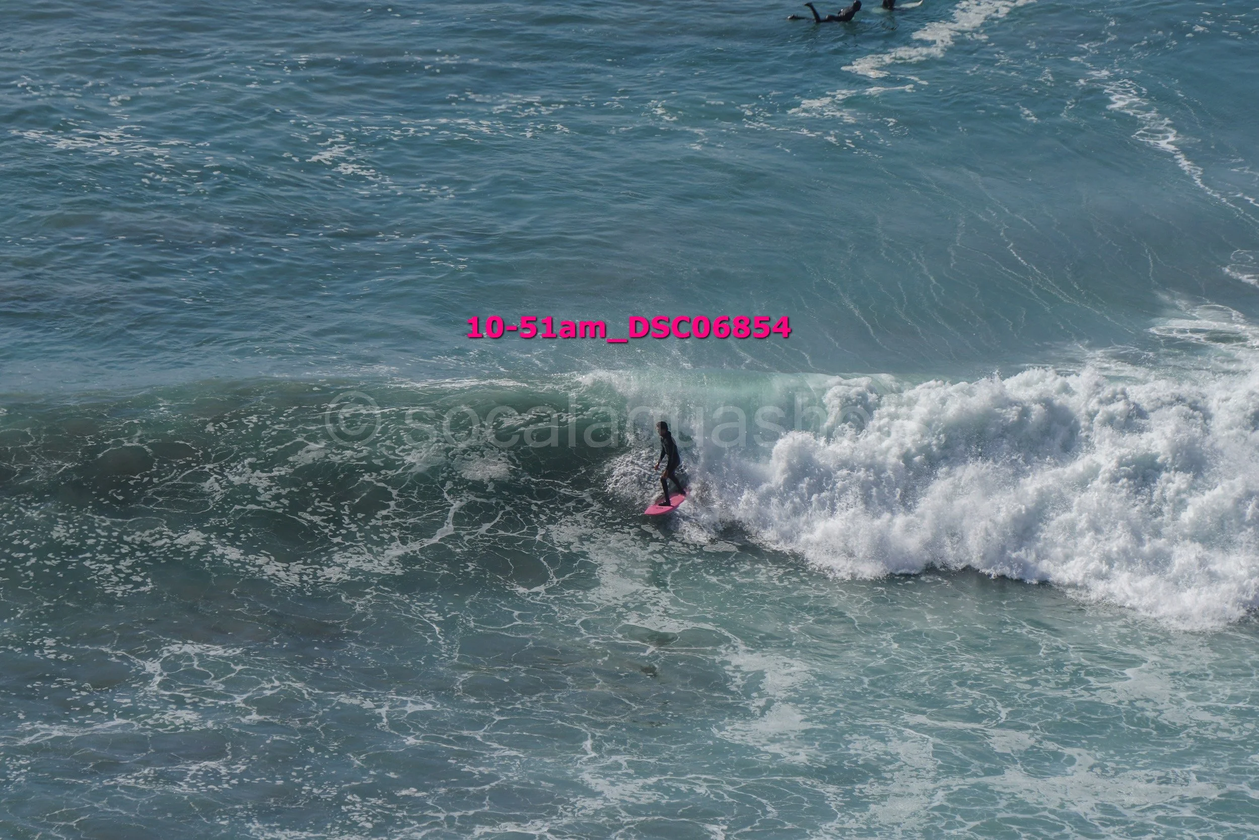 A person surfing on a wave in the ocean.