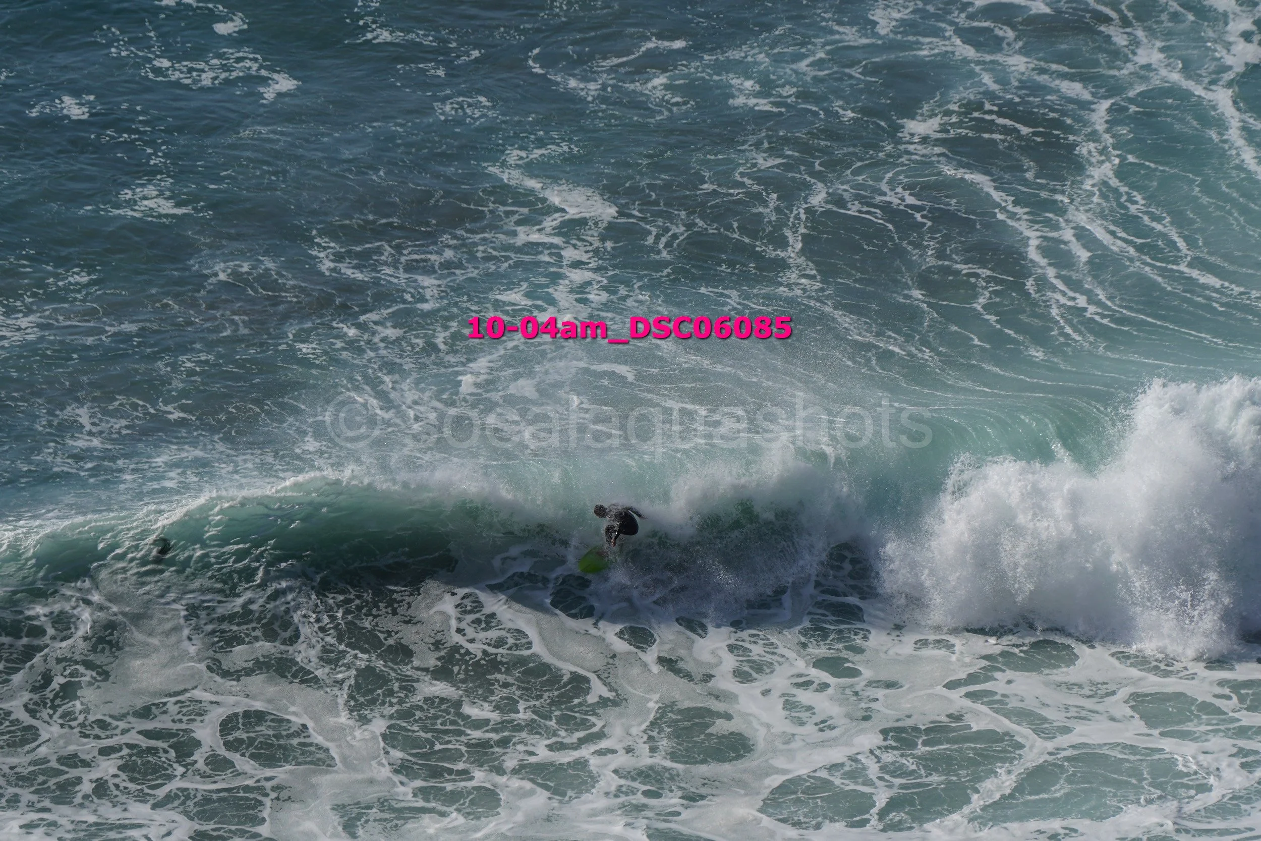 A person surfing on a wave in the ocean.