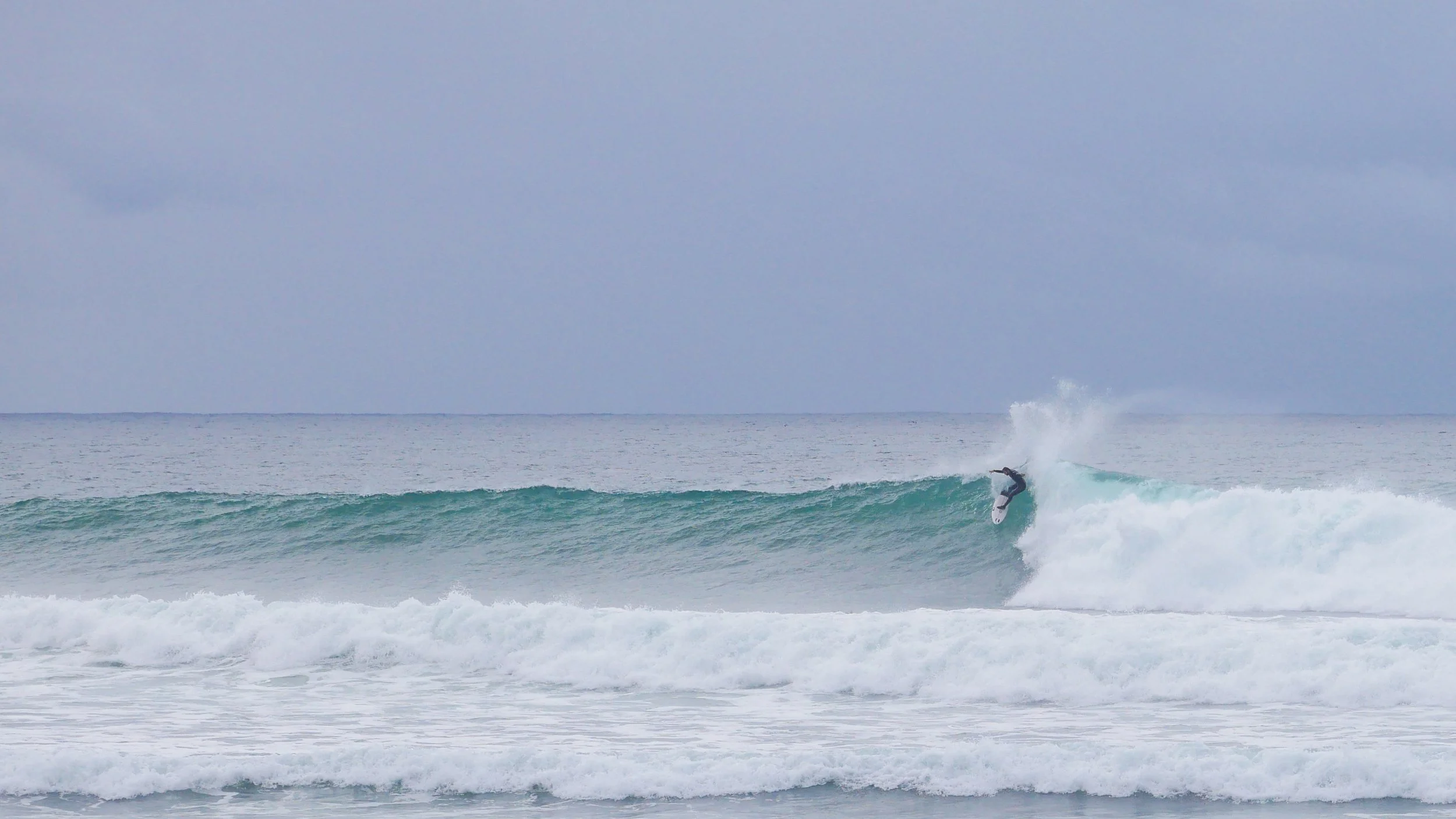 Surfer riding a wave in the ocean
