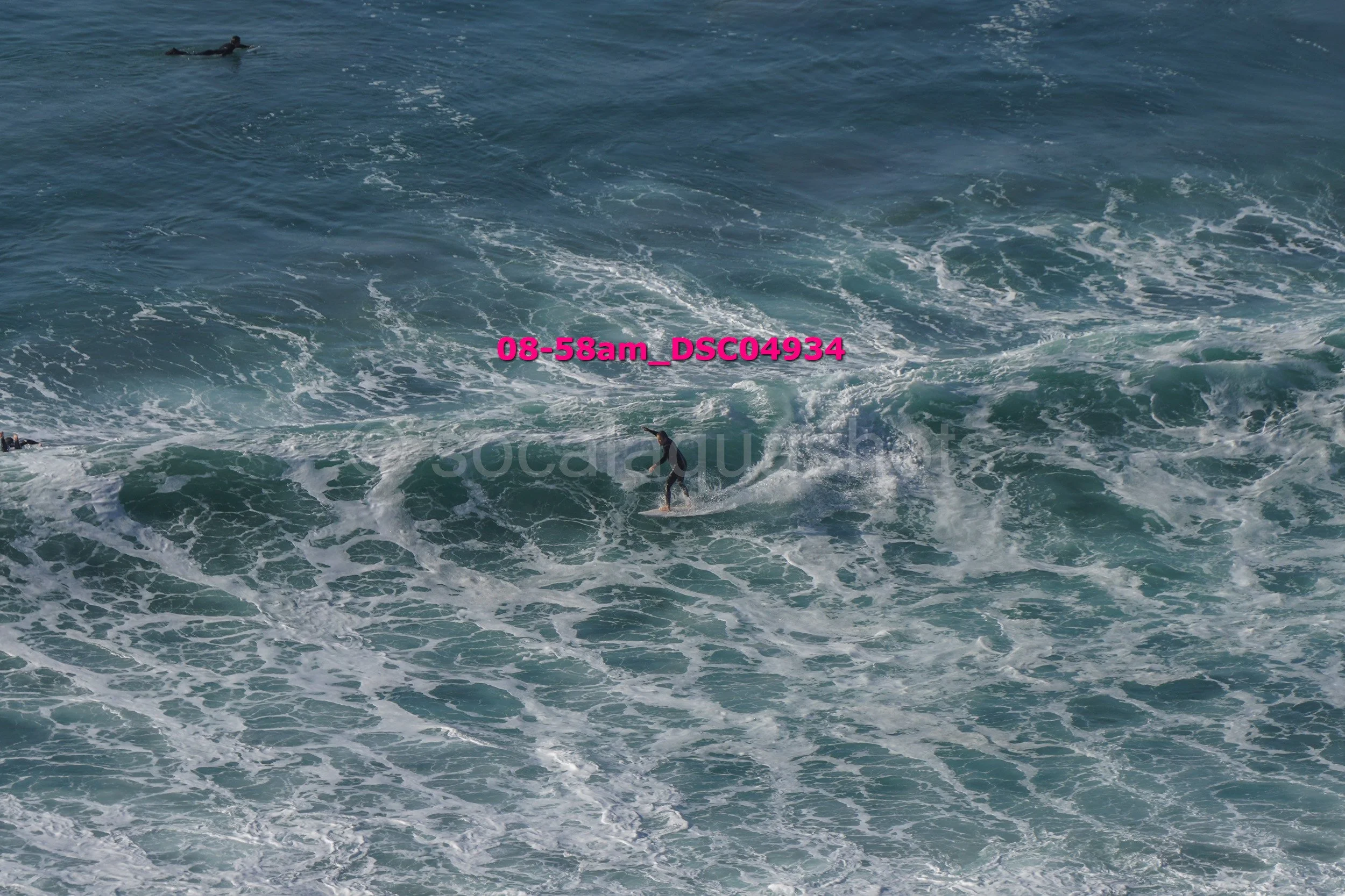 Surfer riding a wave in the ocean during daylight