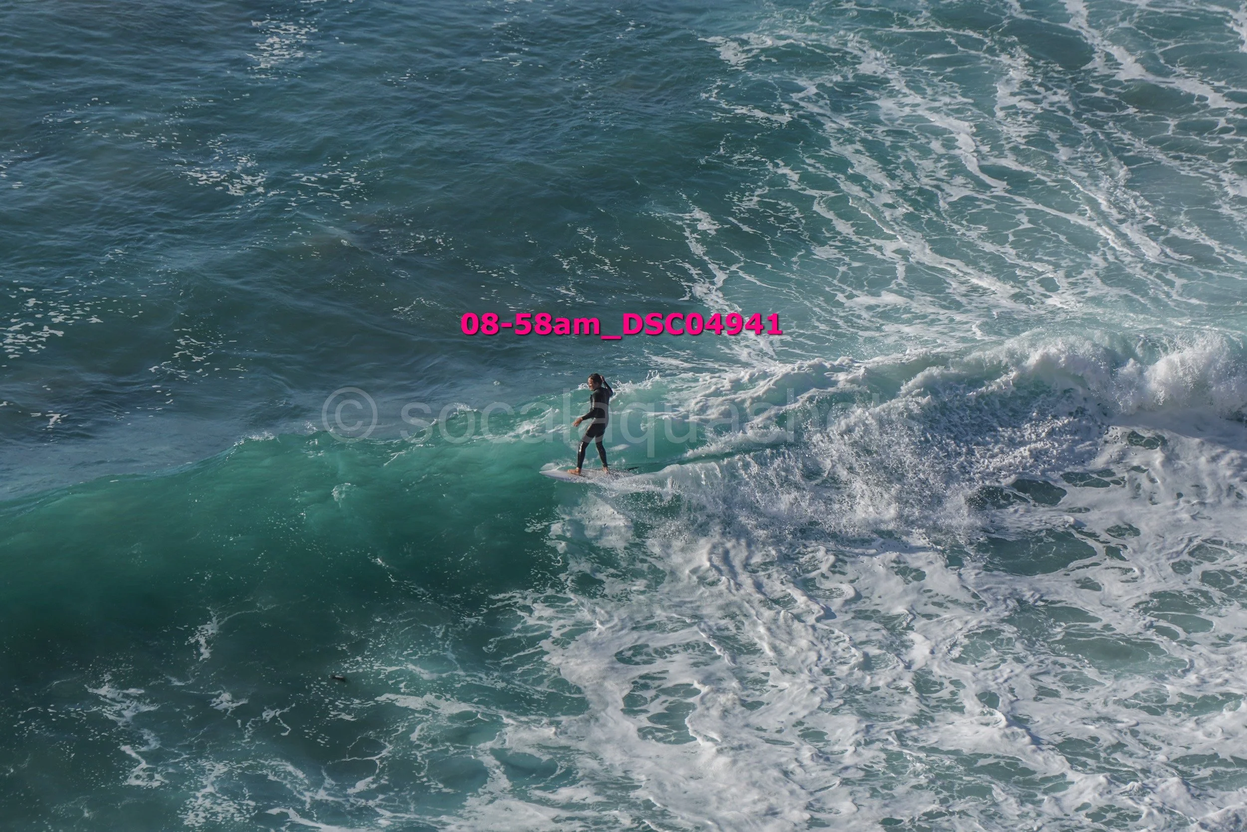 A person surfing on a wave in the ocean.