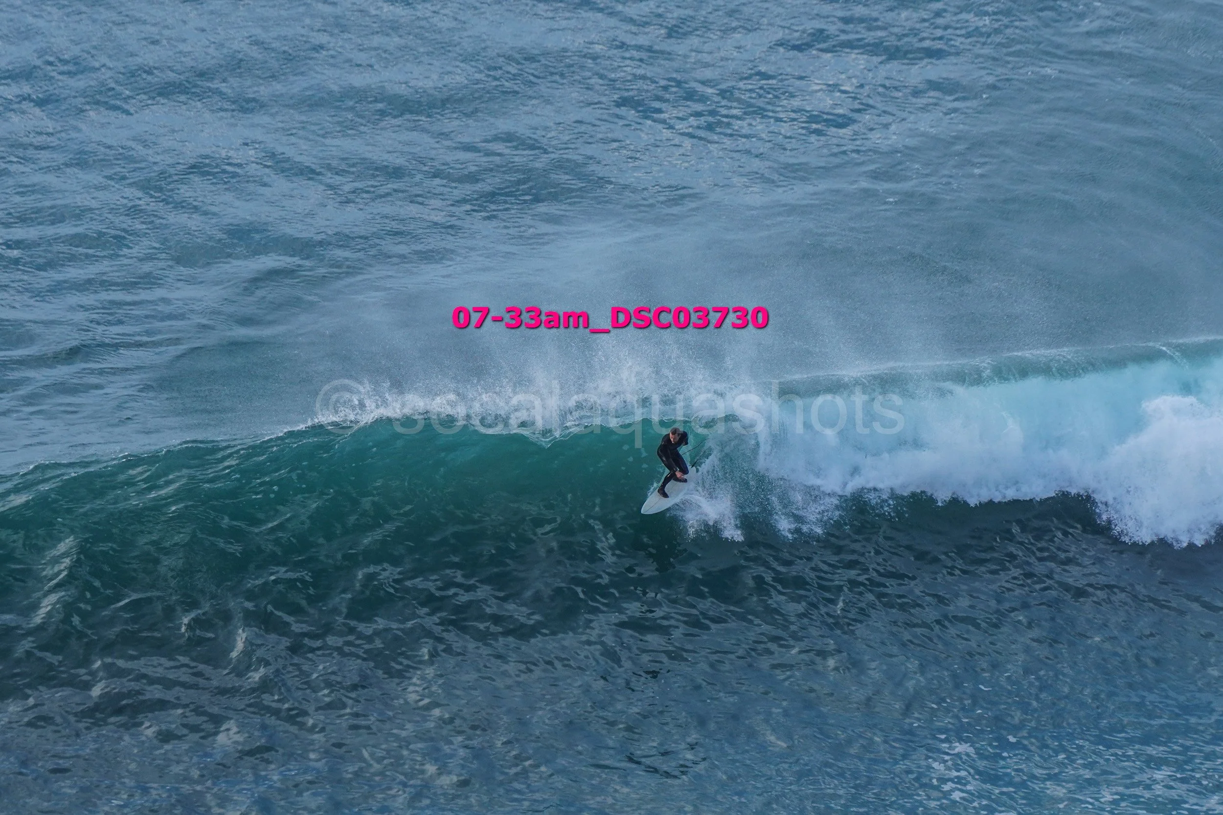 A person surfing on a wave in the ocean during daytime.