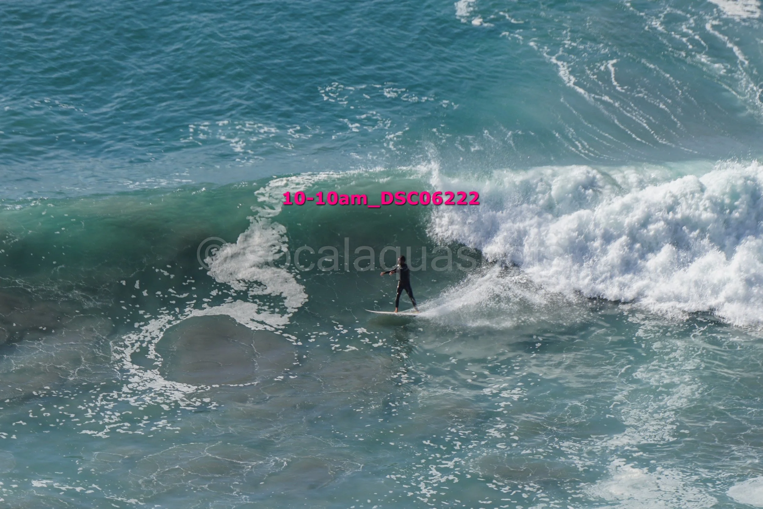 A person surfing a large wave in the ocean.