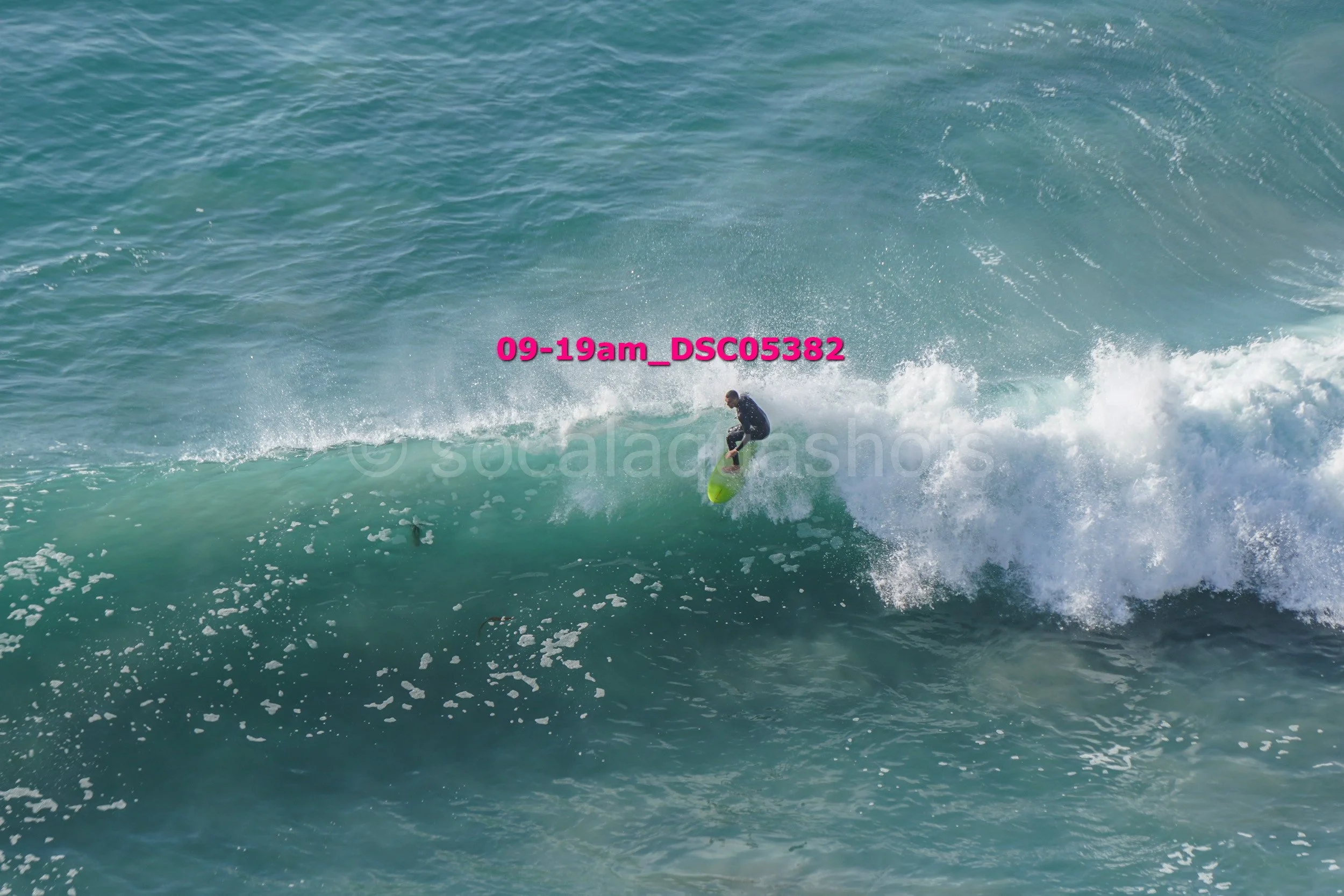 A person riding a wave on a surfboard in the ocean.