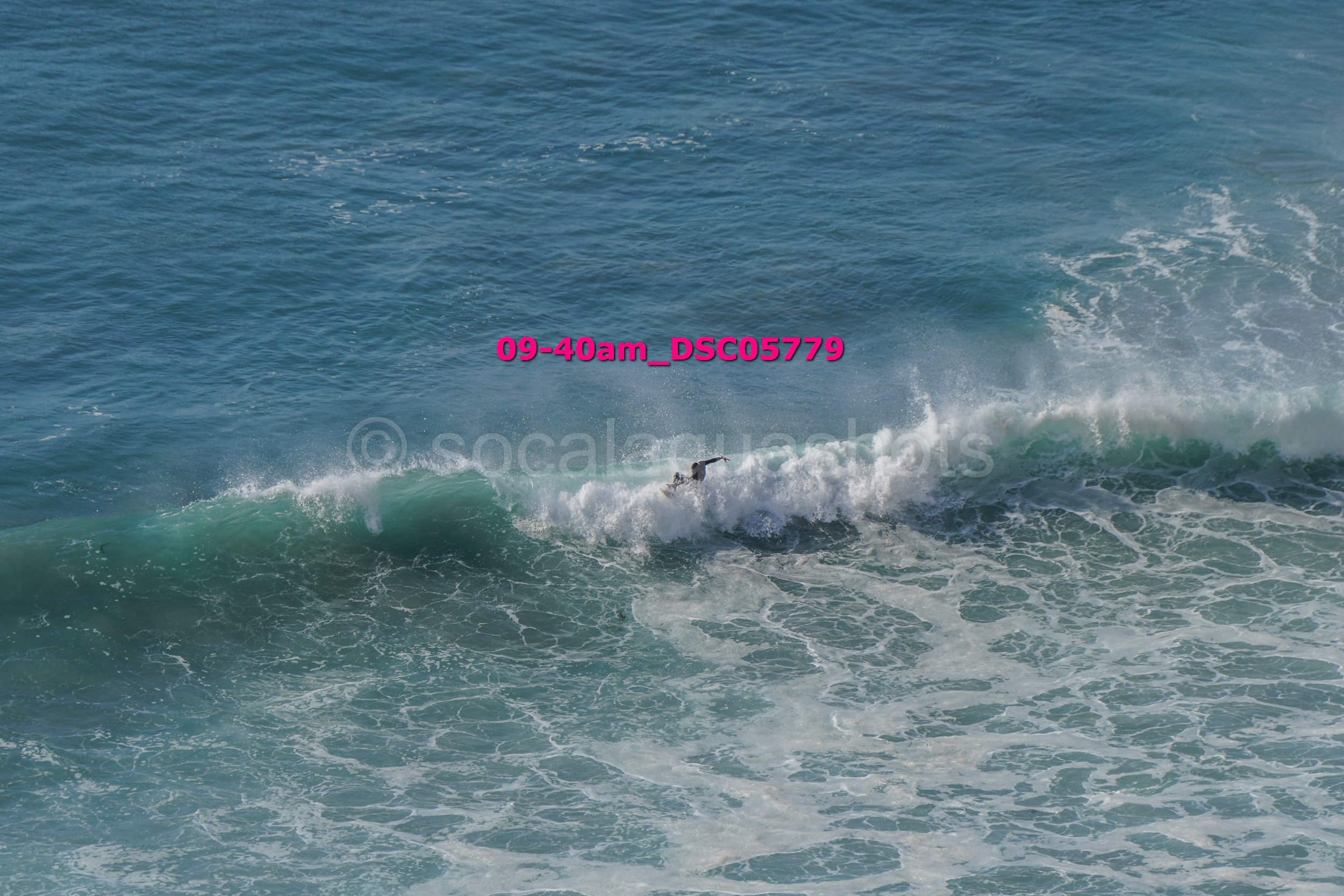 A surfer riding a wave in the ocean.