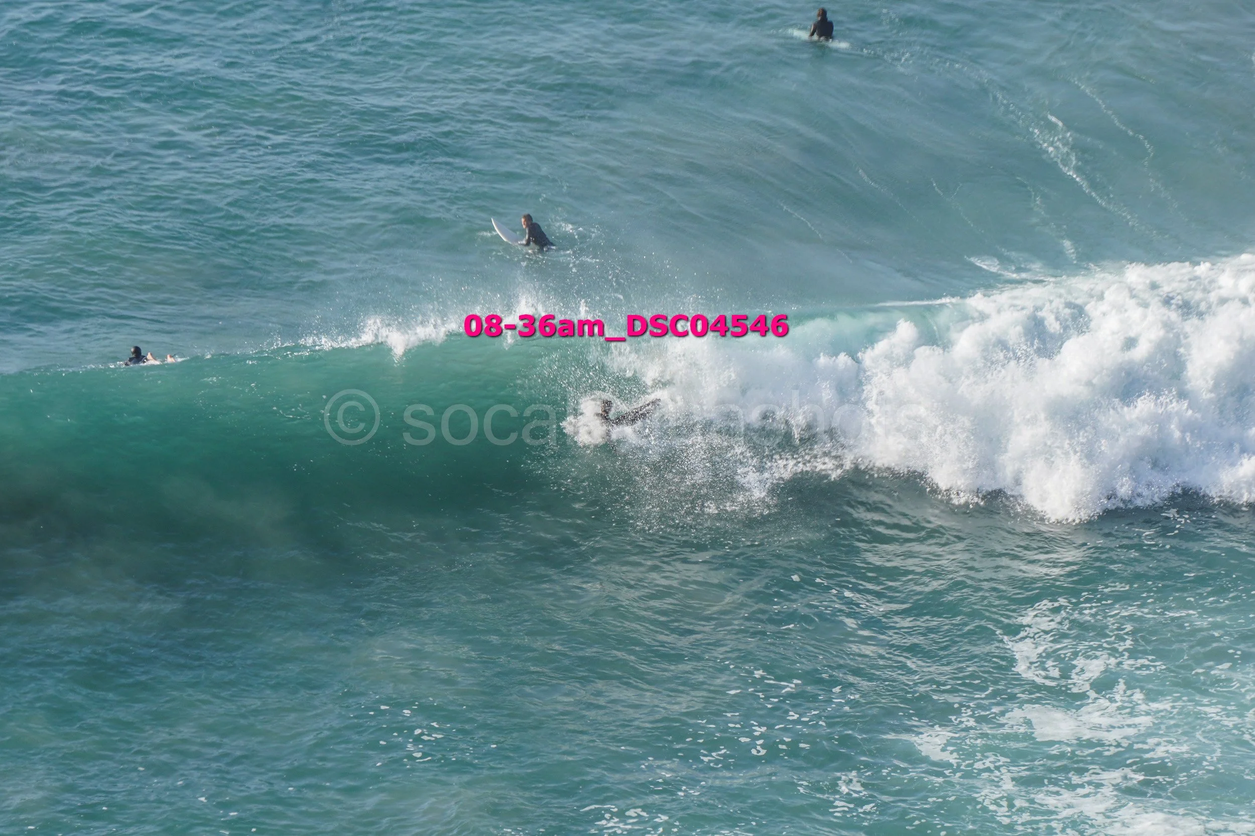Surfers riding waves in the ocean.