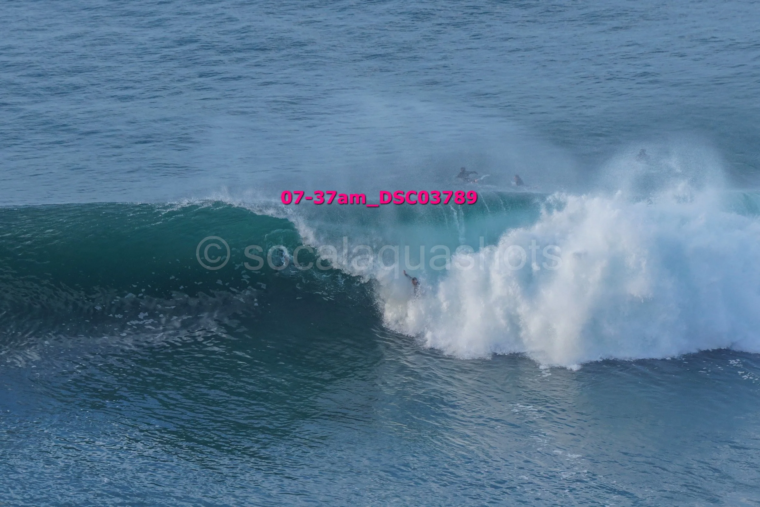 Surfer falling off a wave in the ocean.