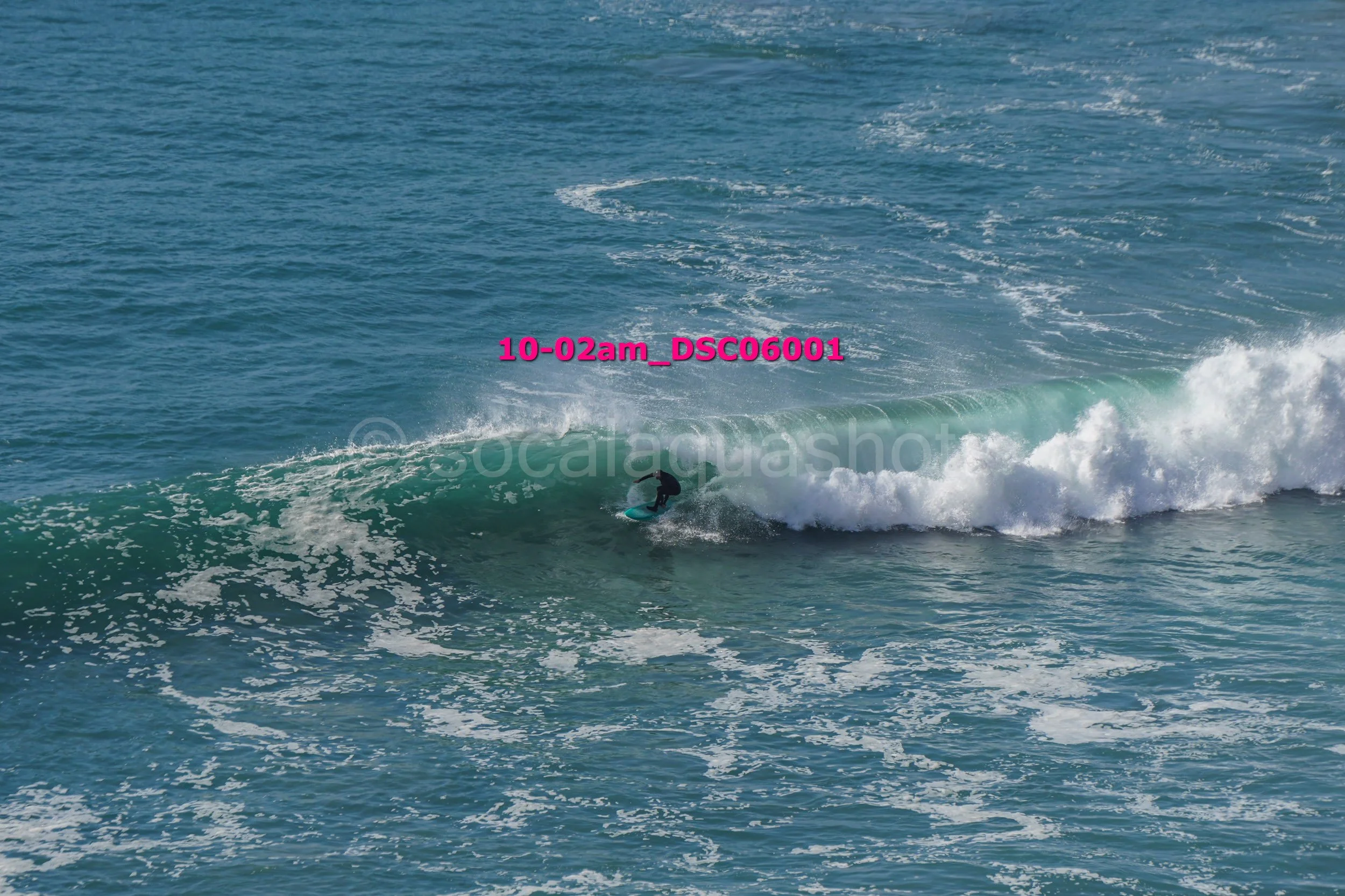 A person surfing on a wave in the ocean.