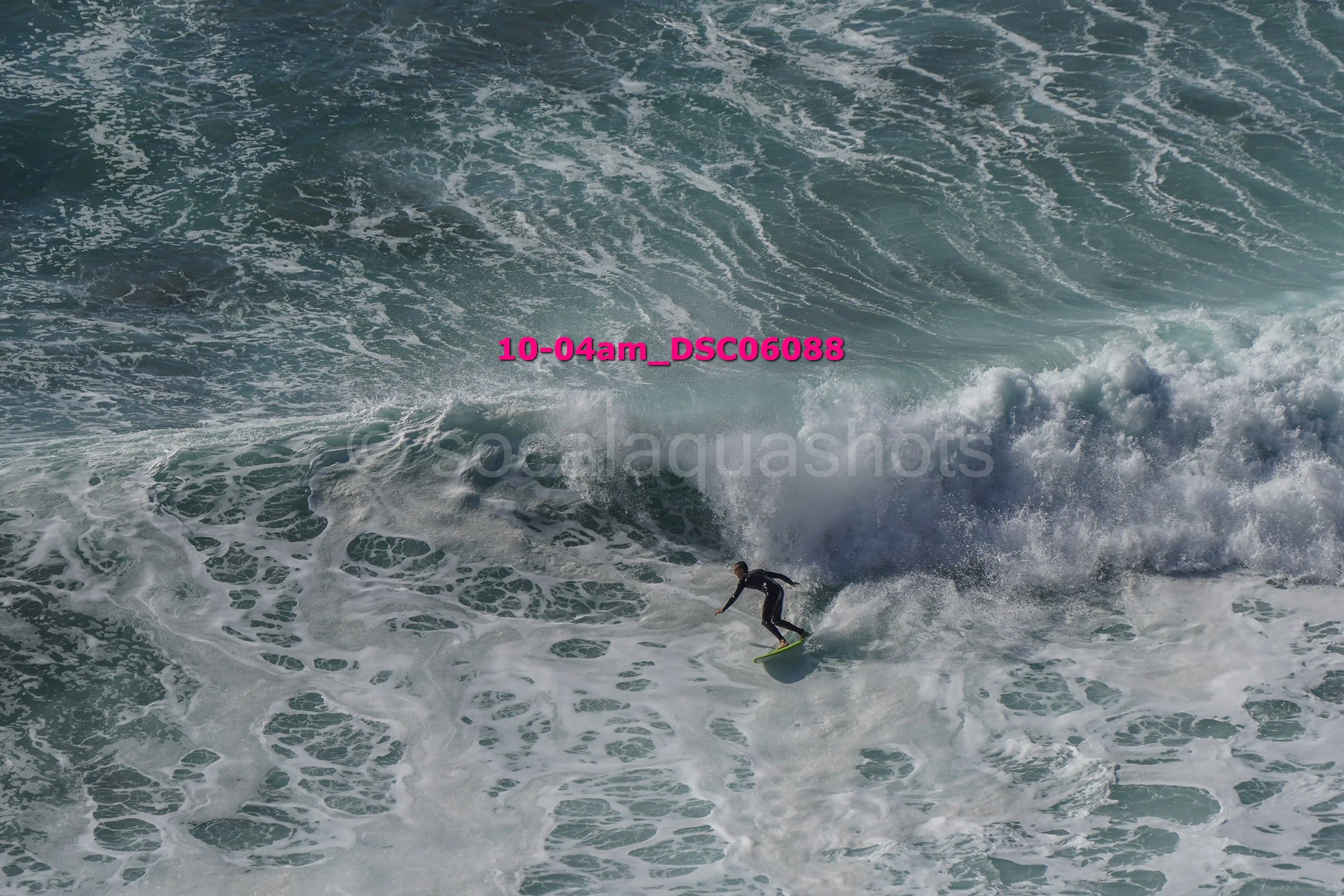 A person surfing on a wave in the ocean.