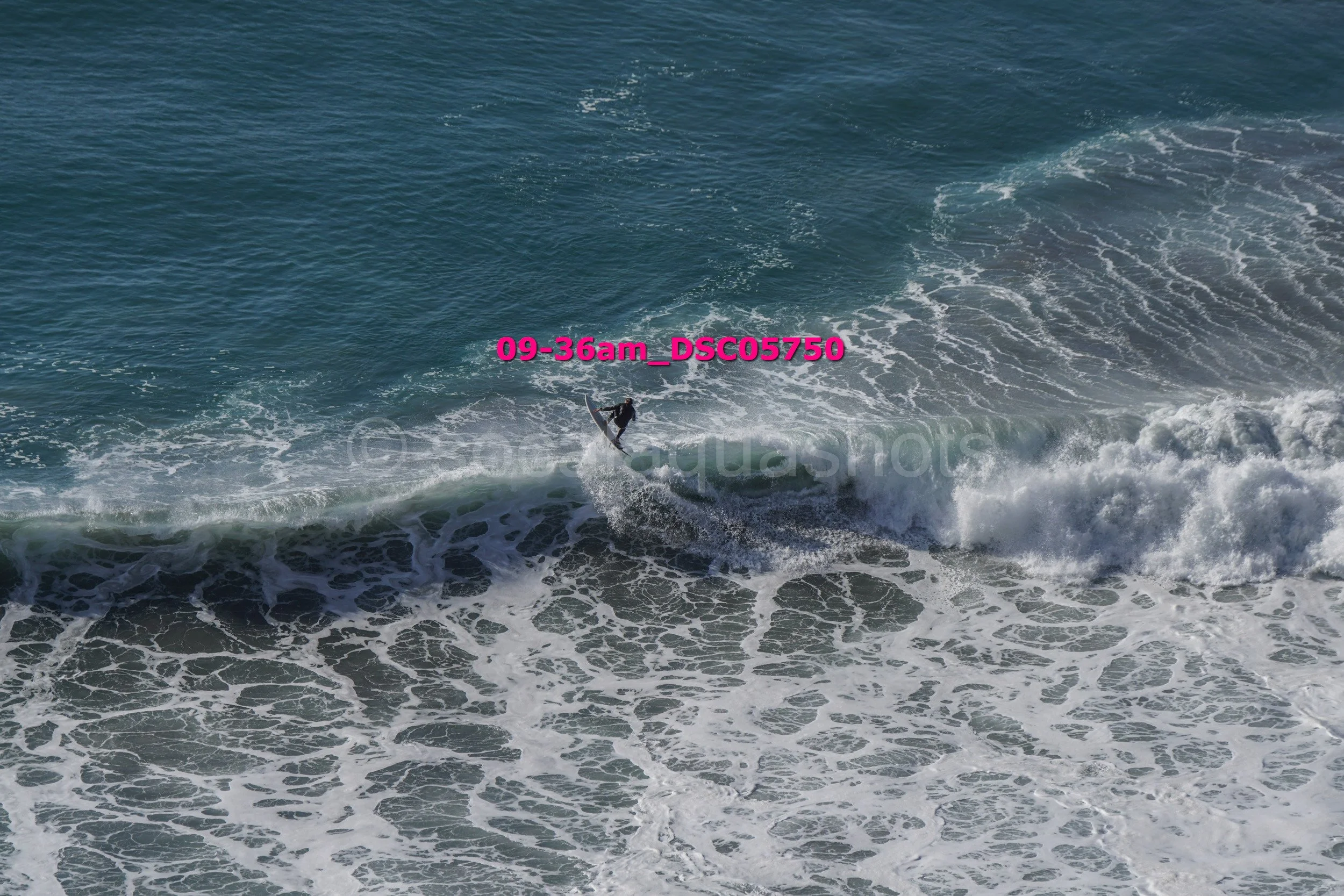 A person surfing on a wave in the ocean.