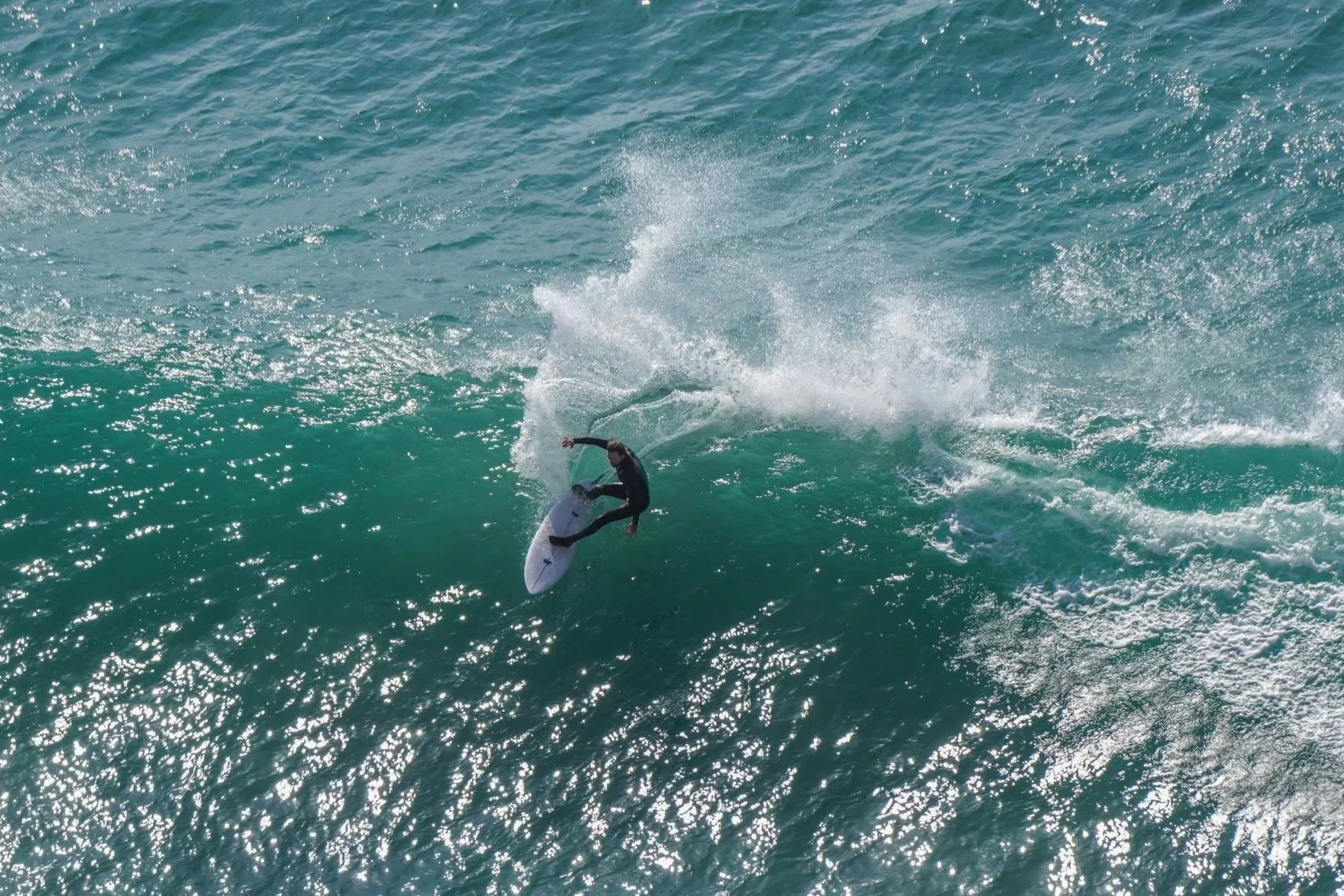 Surfer performing a trick on a wave in the ocean.