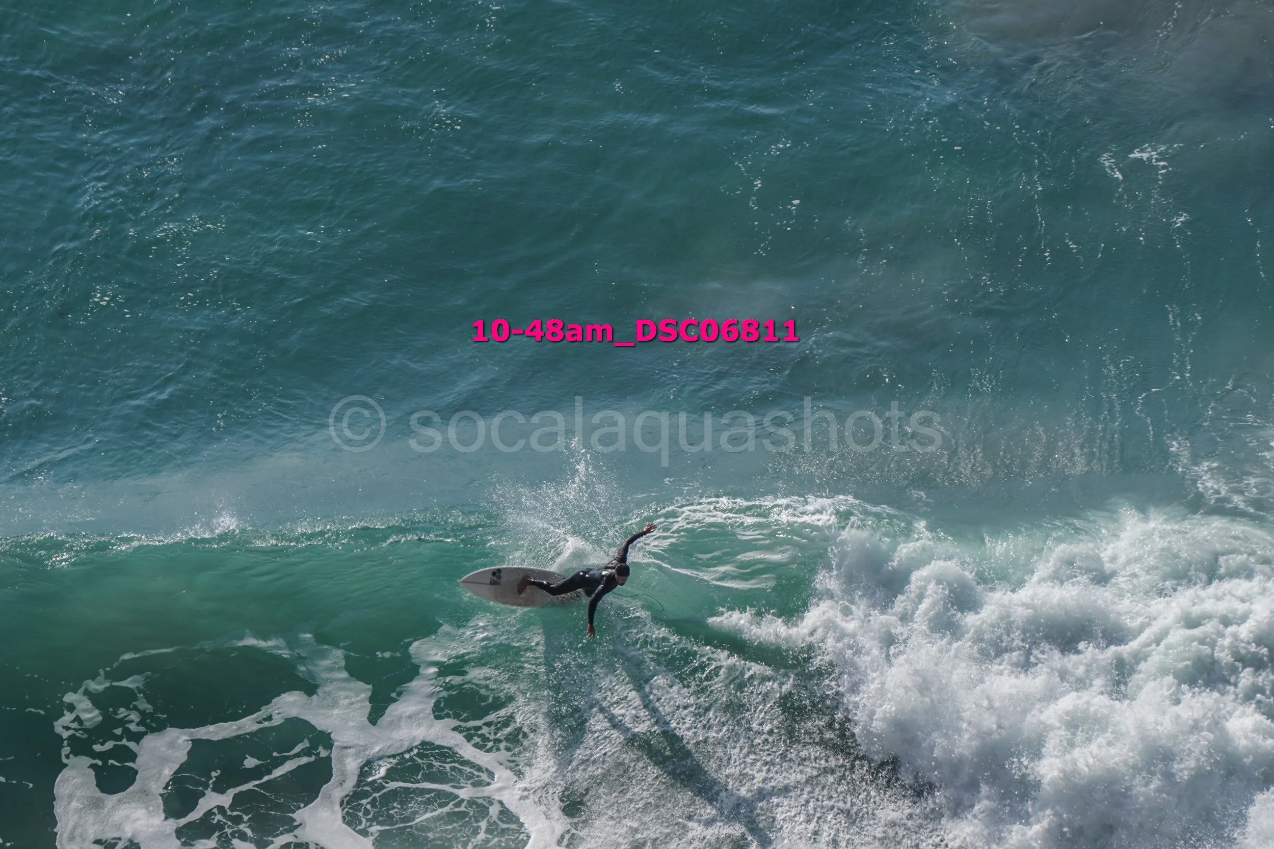 Surfer riding a wave in the ocean.