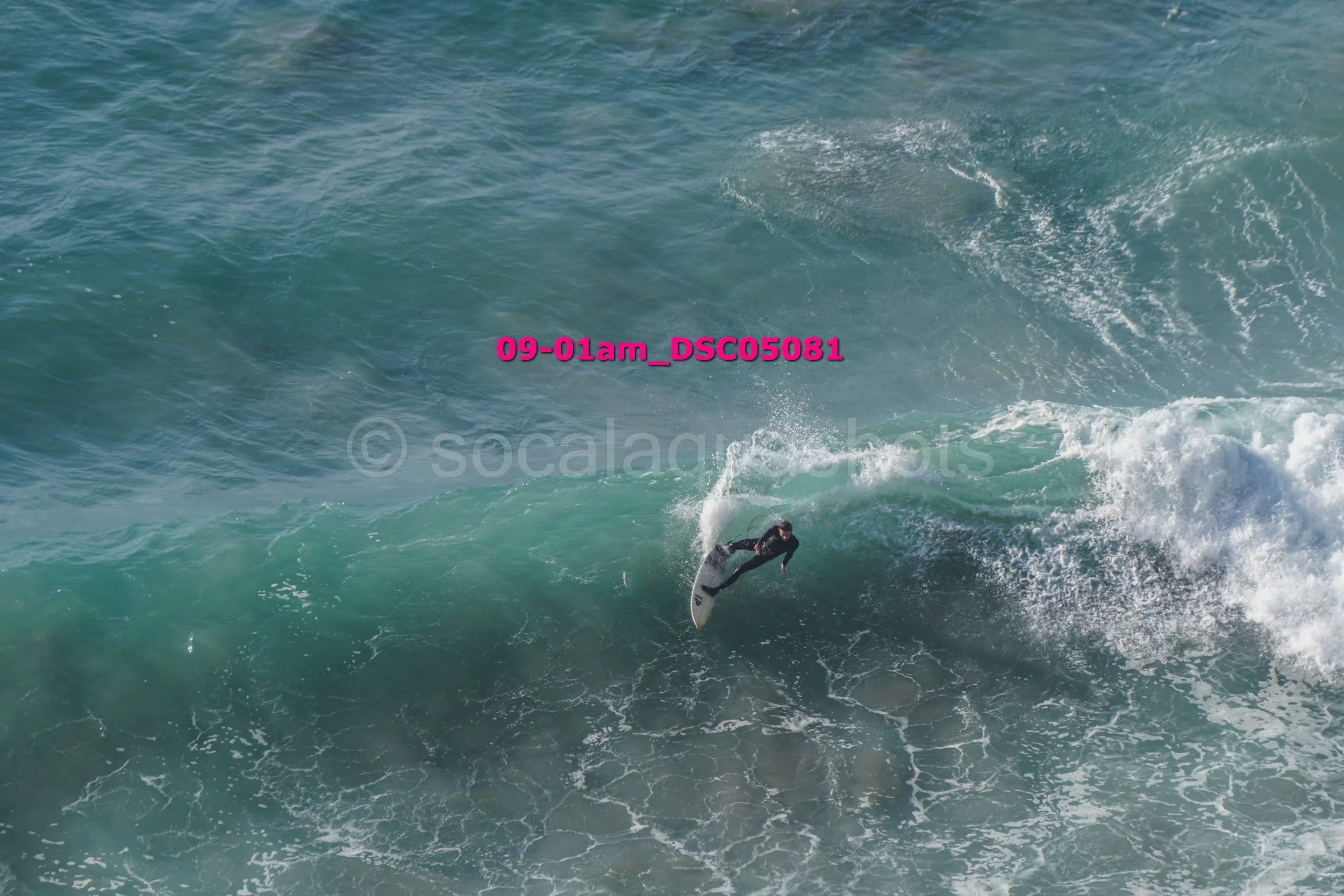 A surfer riding a wave in the ocean.