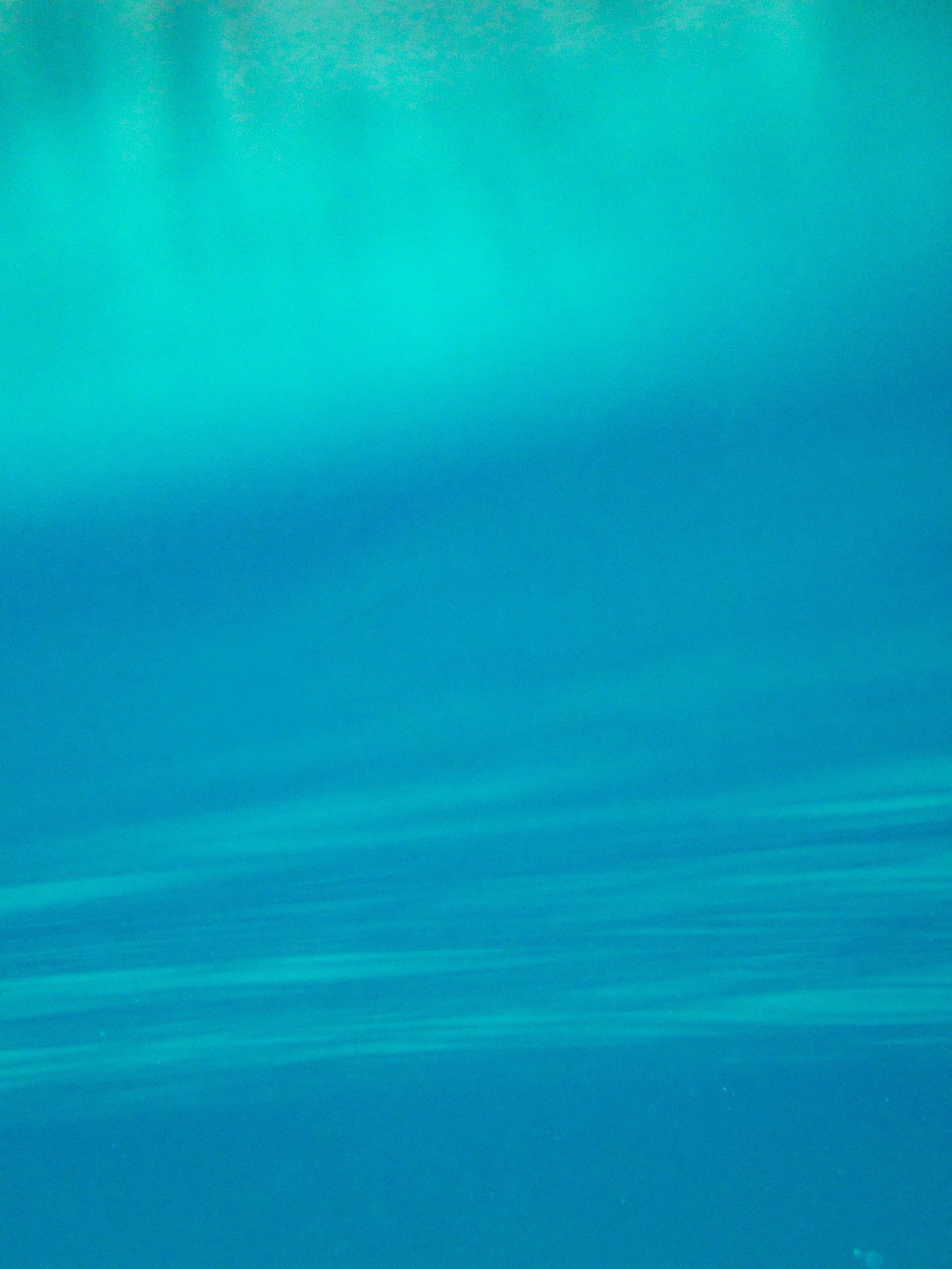 Abstract blue gradient background with subtle horizontal lines.