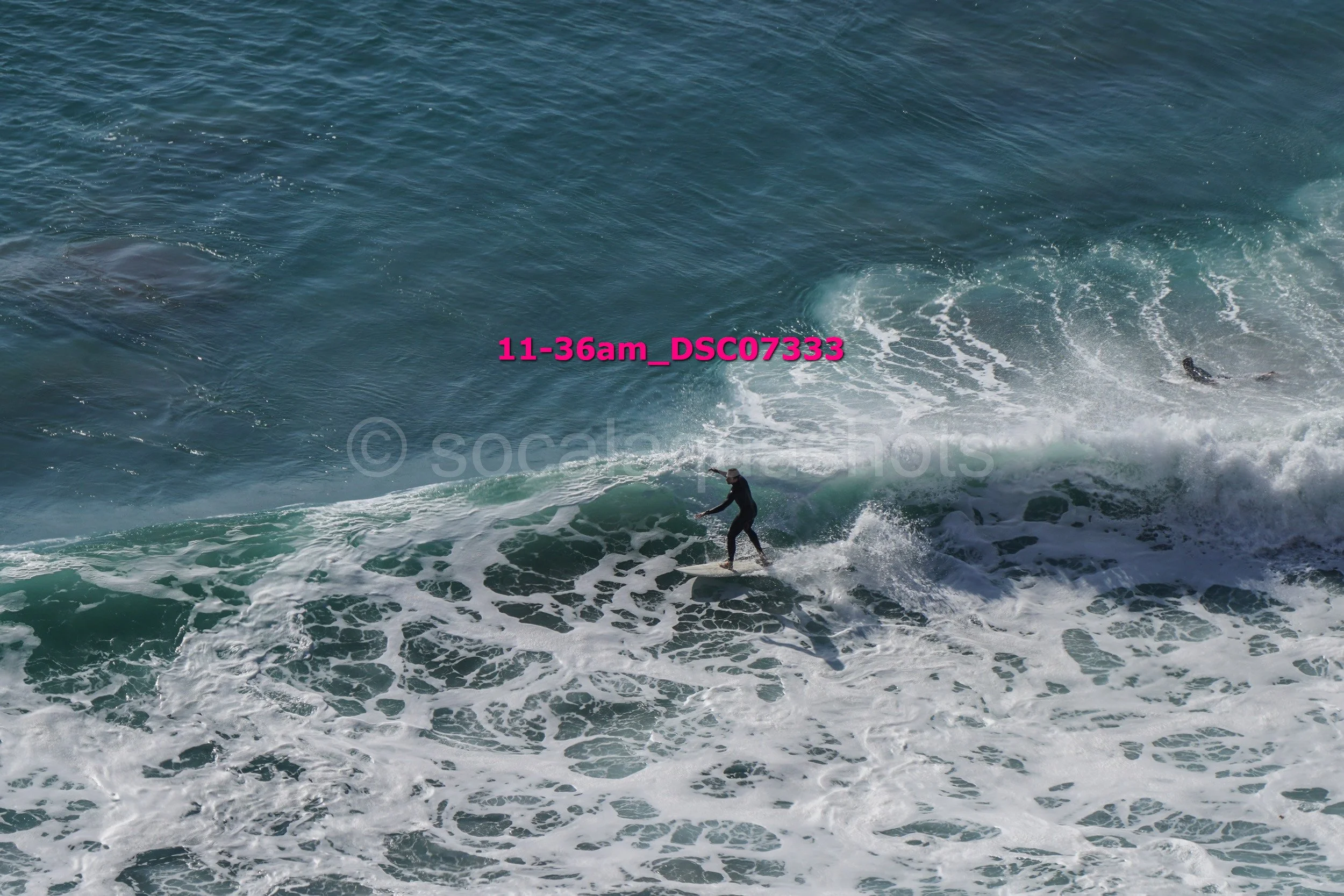 A person surfing on a wave in the ocean during daytime.