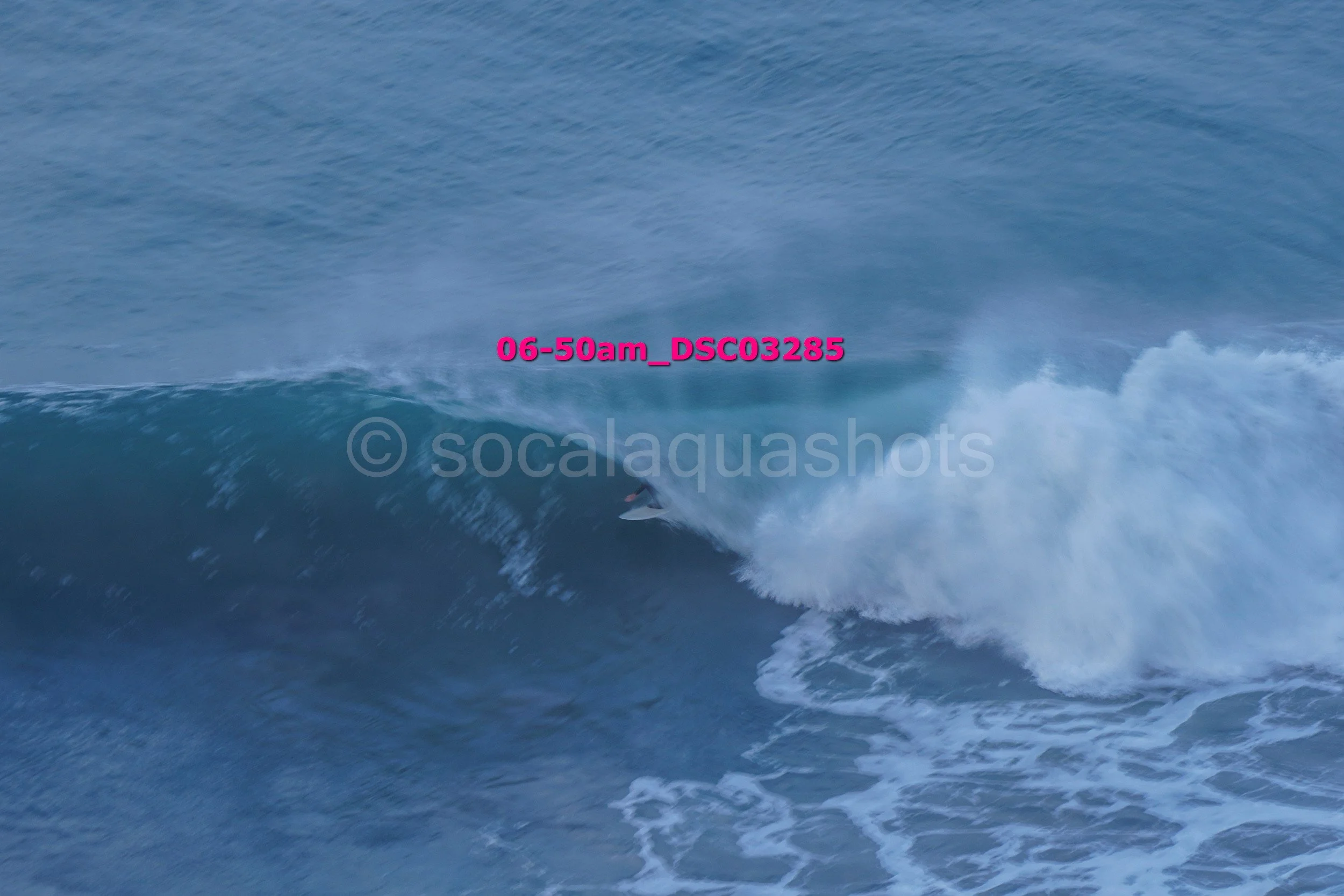 A surfer riding a wave in the ocean.