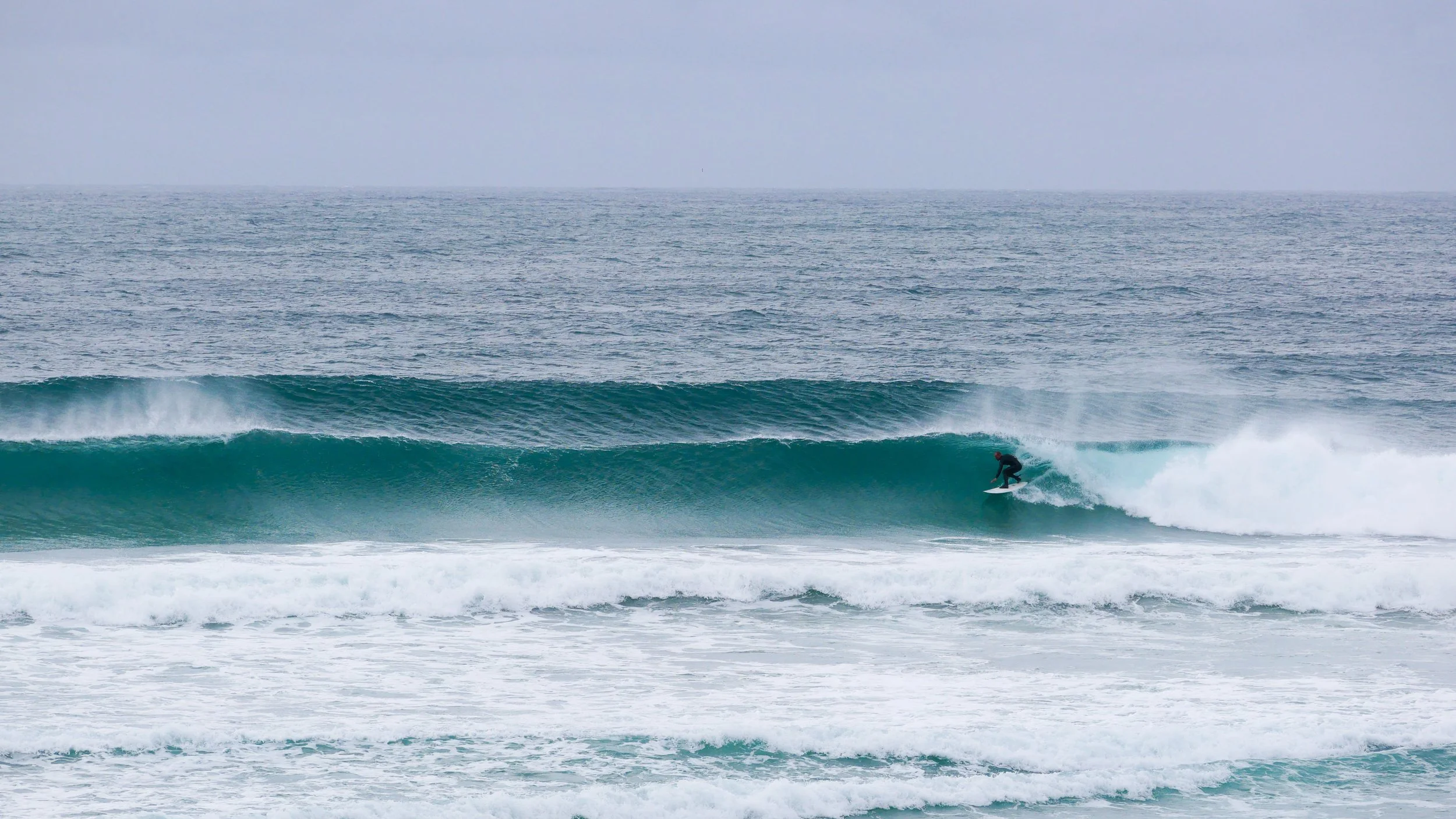 Surfer riding a large ocean wave