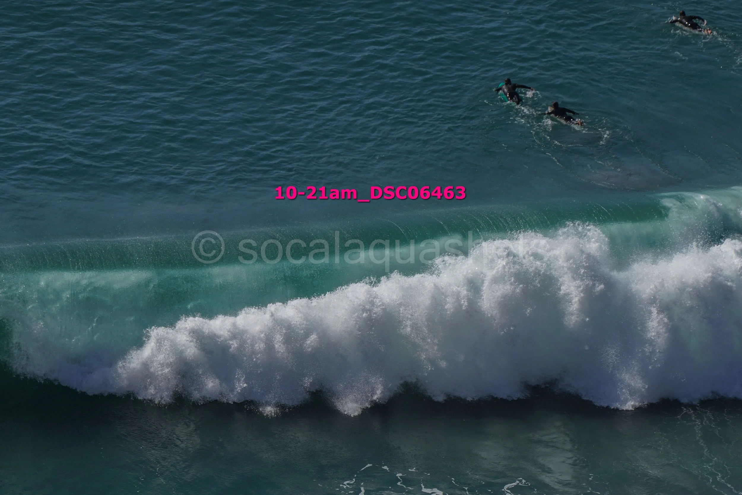 People surfing on a wave in the ocean.