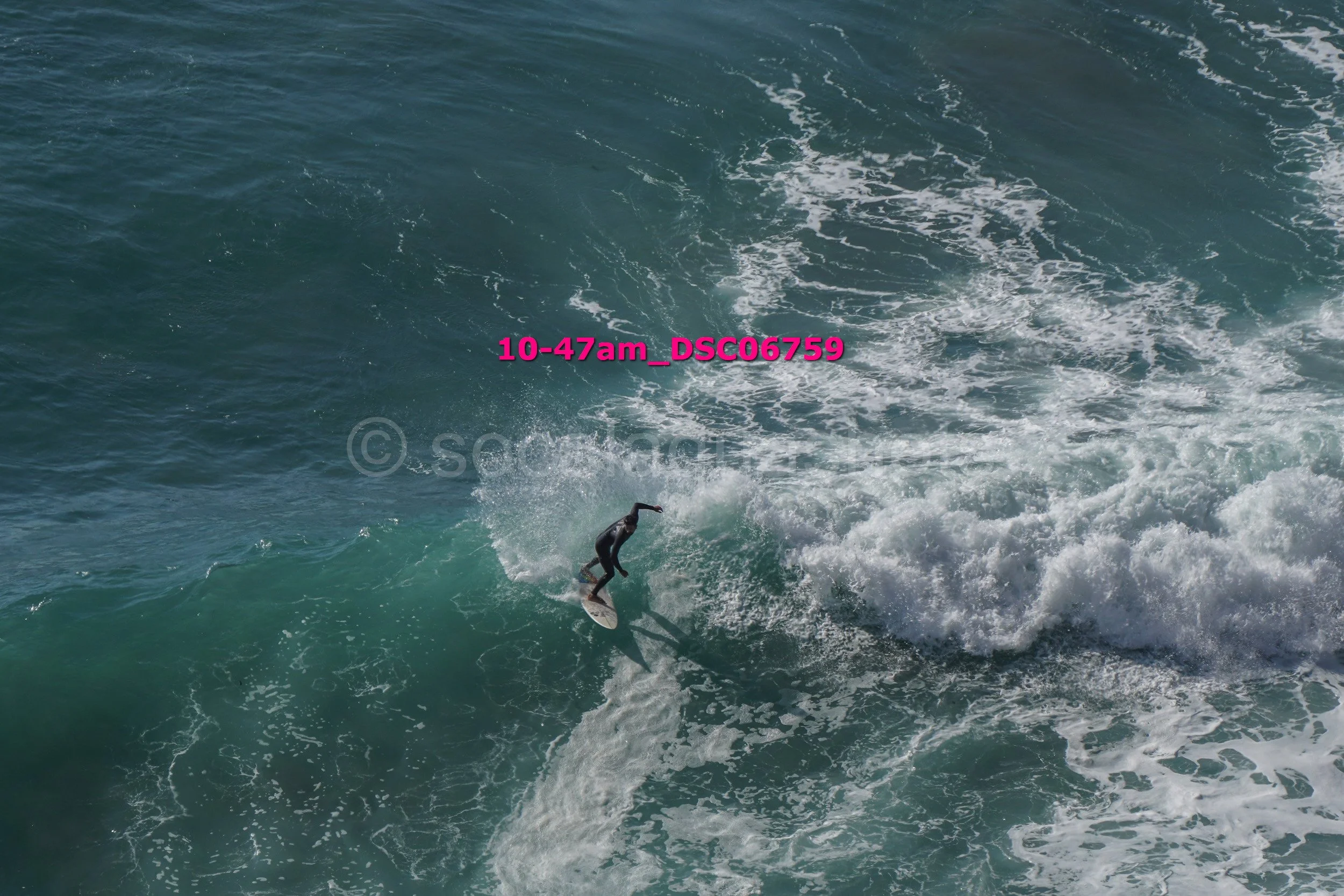 A person surfing on a wave in the ocean.
