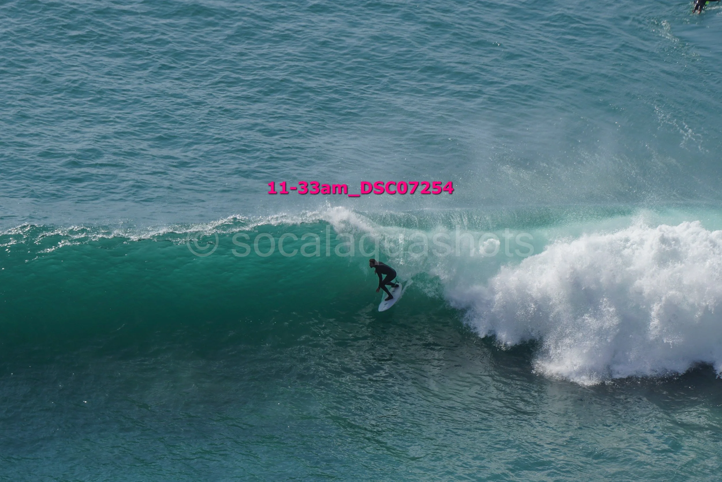 A surfer riding a wave in the ocean.