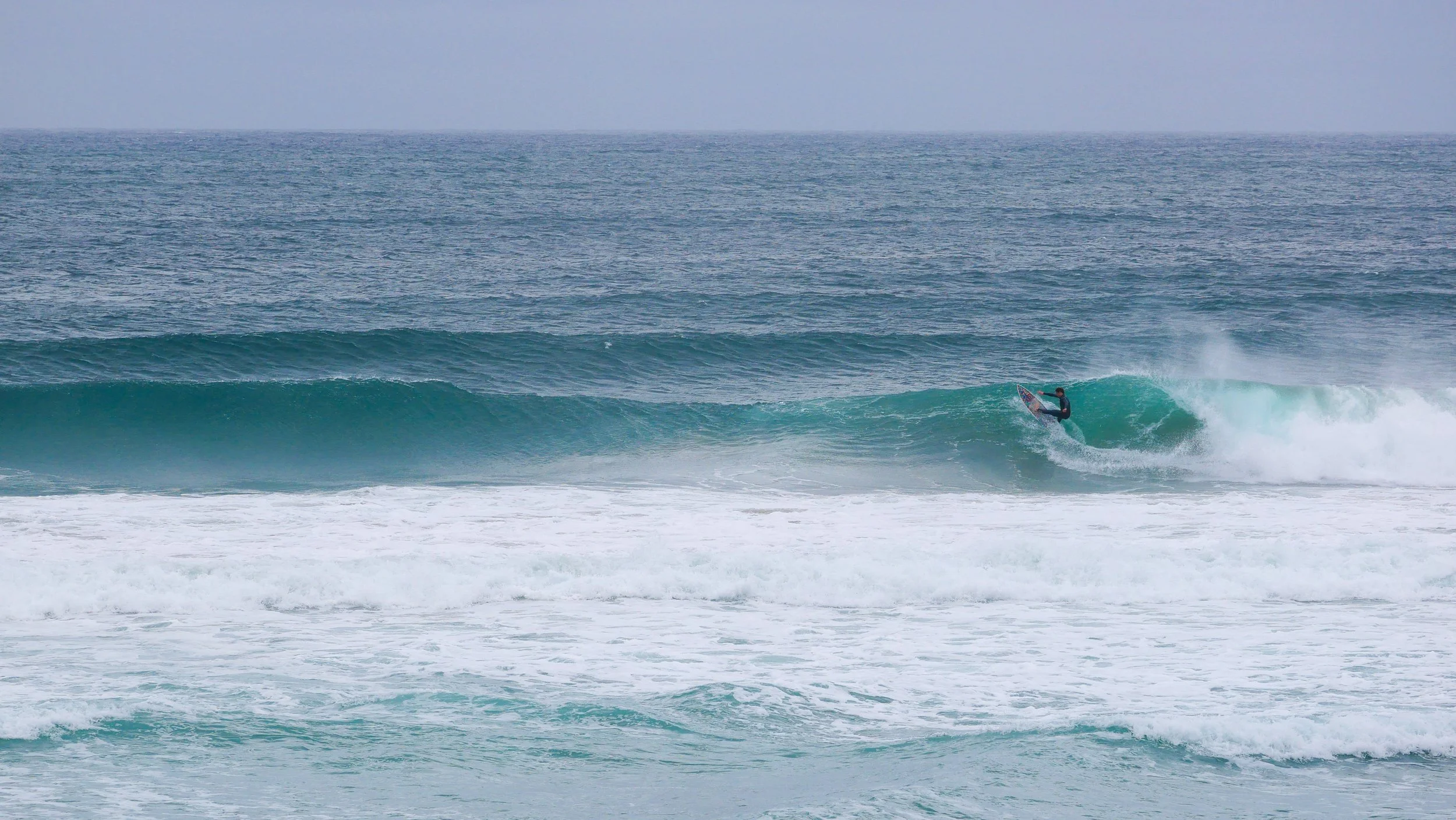 Surfer riding a wave in the ocean