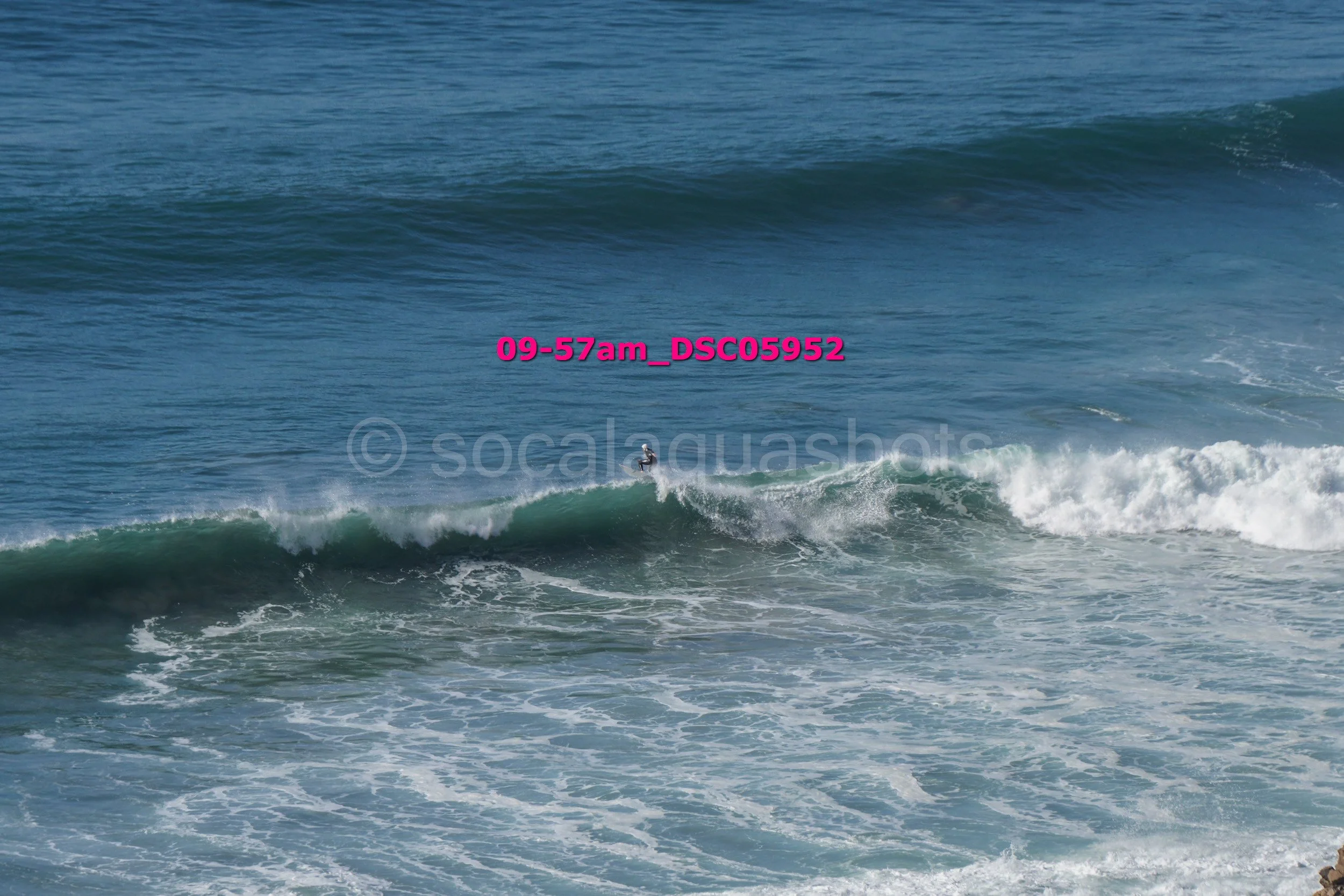 Ocean waves with a surfer riding a wave
