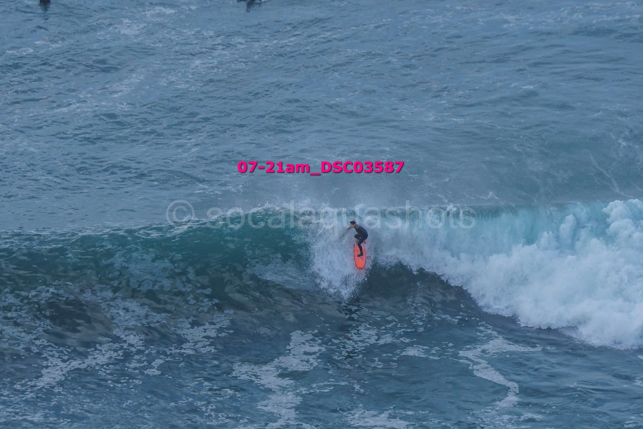 A person surfing on a wave in the ocean.