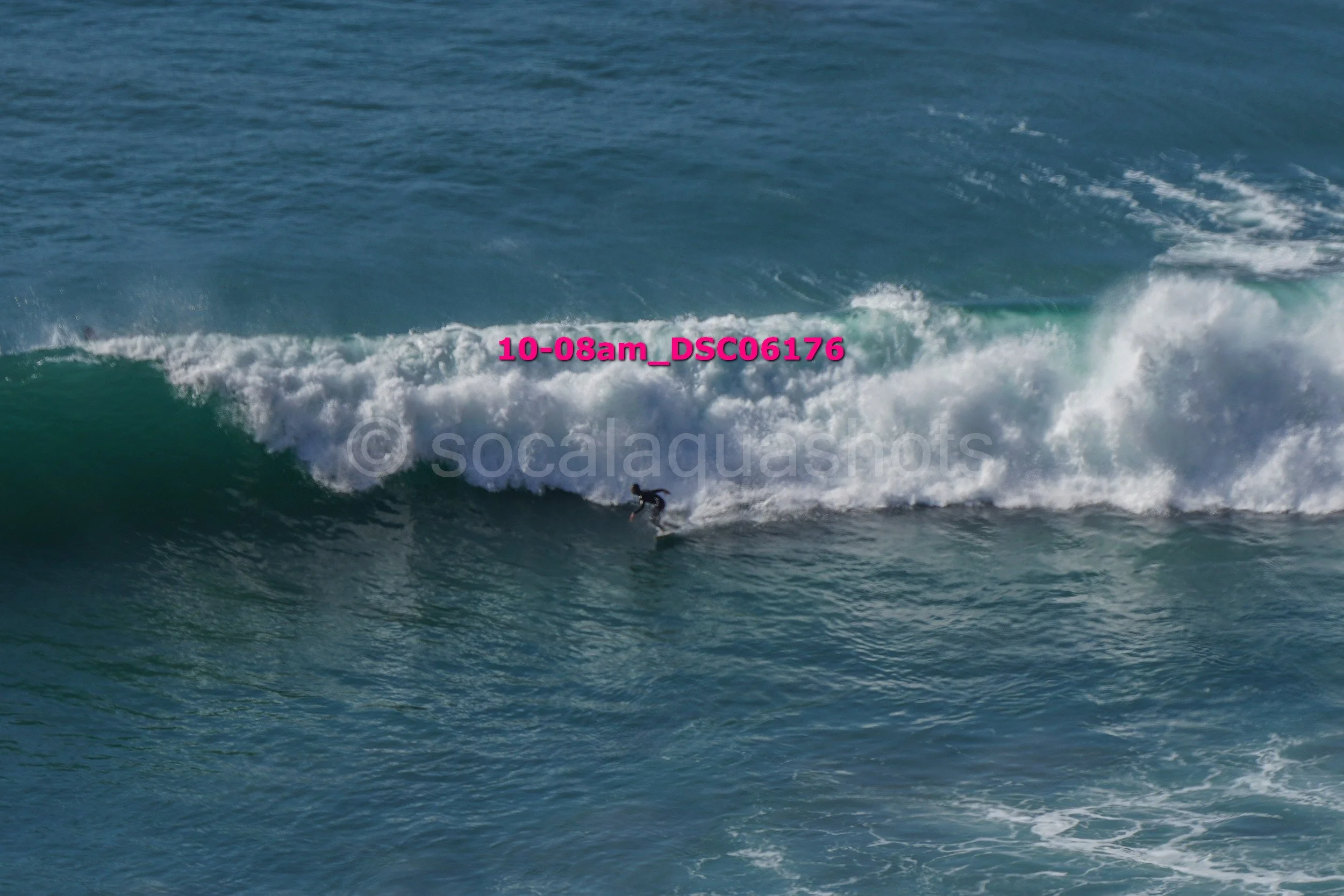 A person surfing on a wave in the ocean, with a watermark and text overlaid on the image.