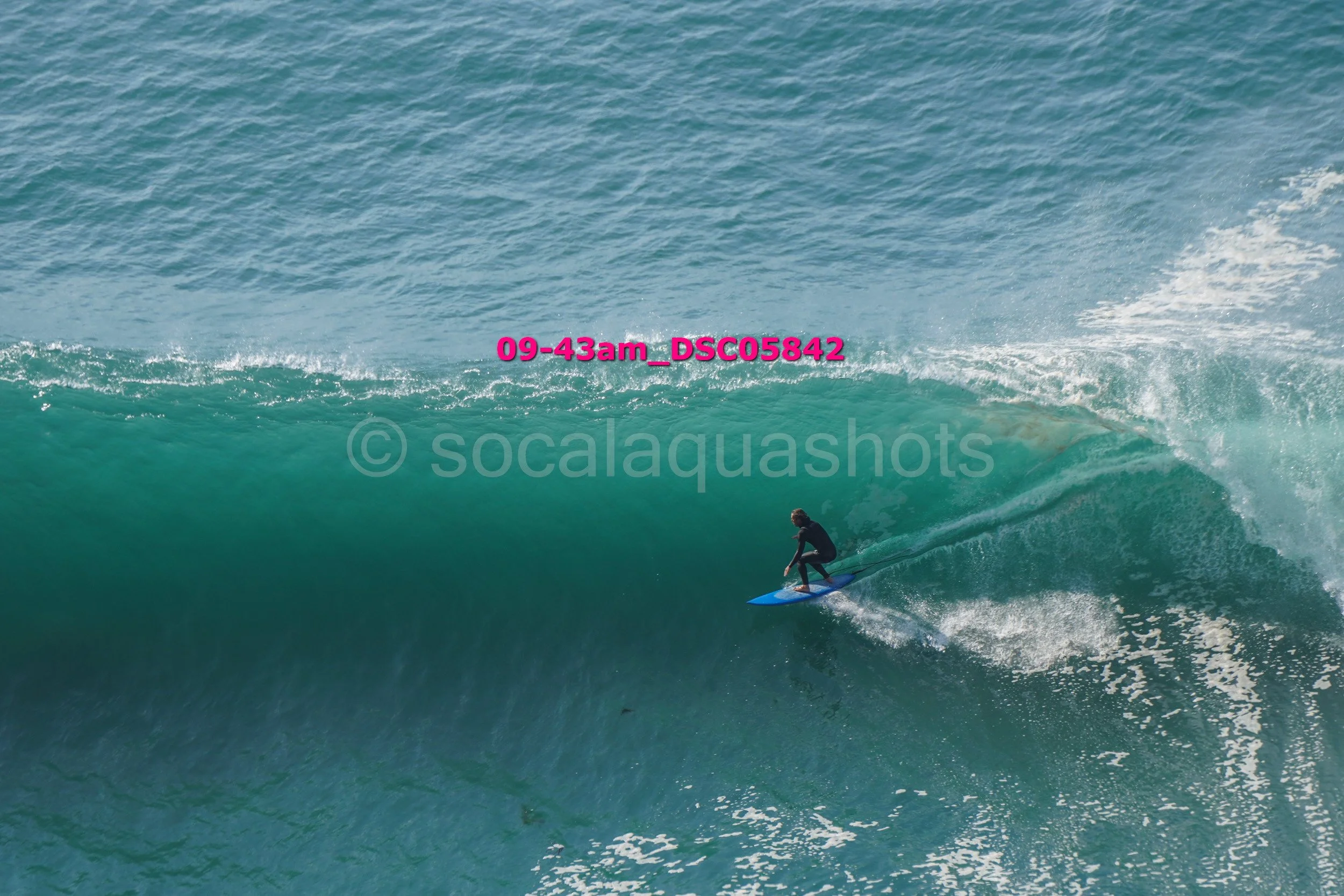 A person surfing on a large ocean wave