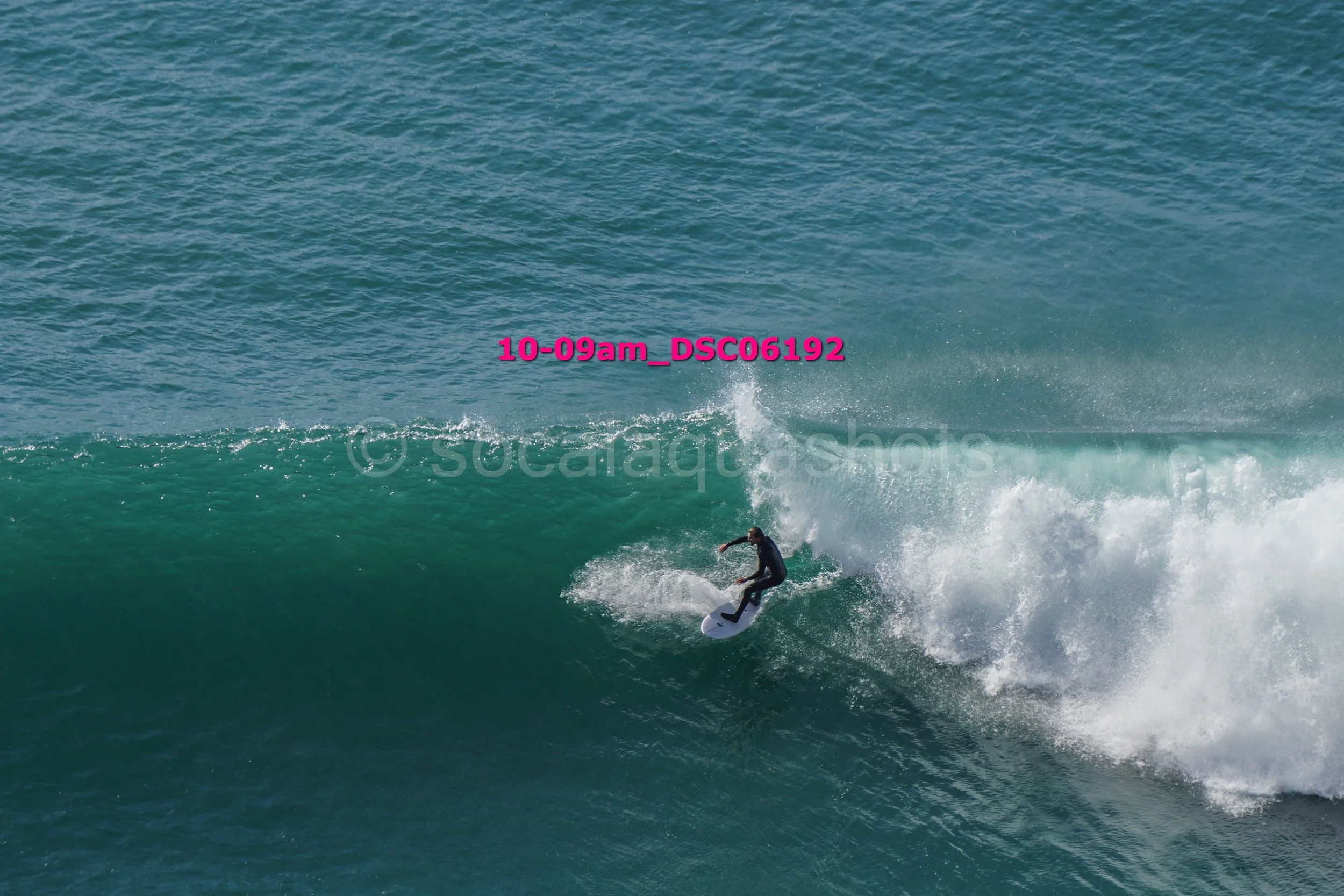 A person surfing on a wave in the ocean.