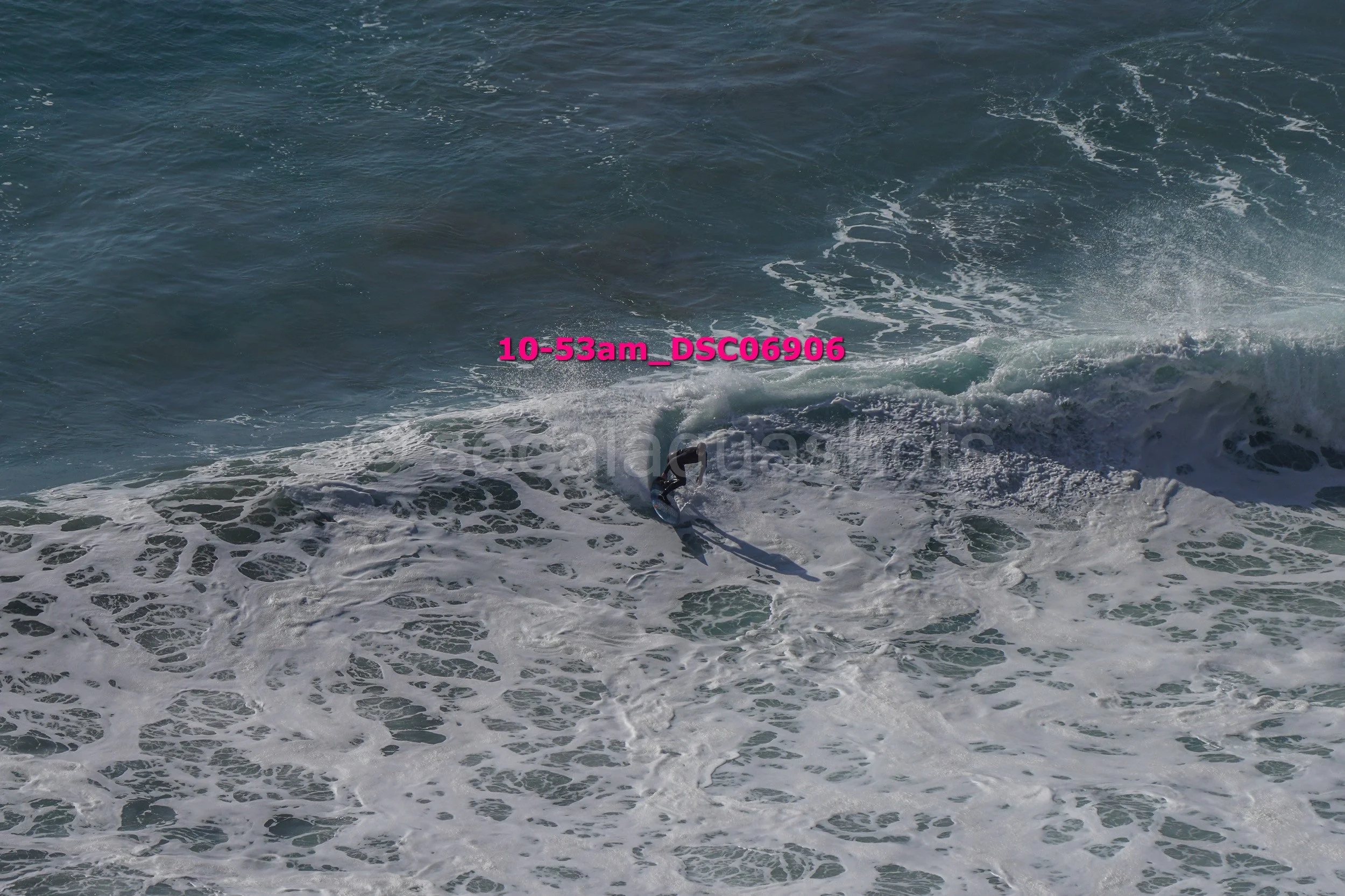 A person surfing on a wave in the ocean.