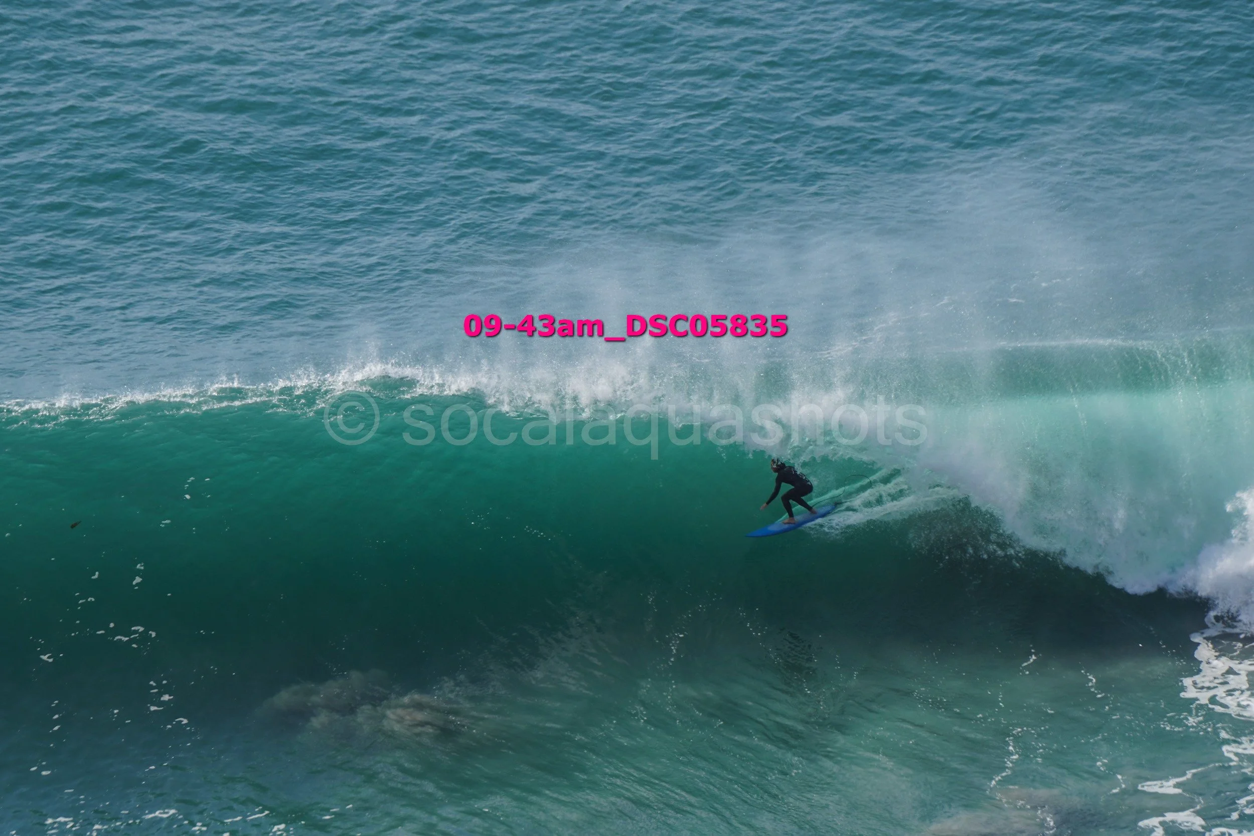 Surfer riding a large wave in the ocean
