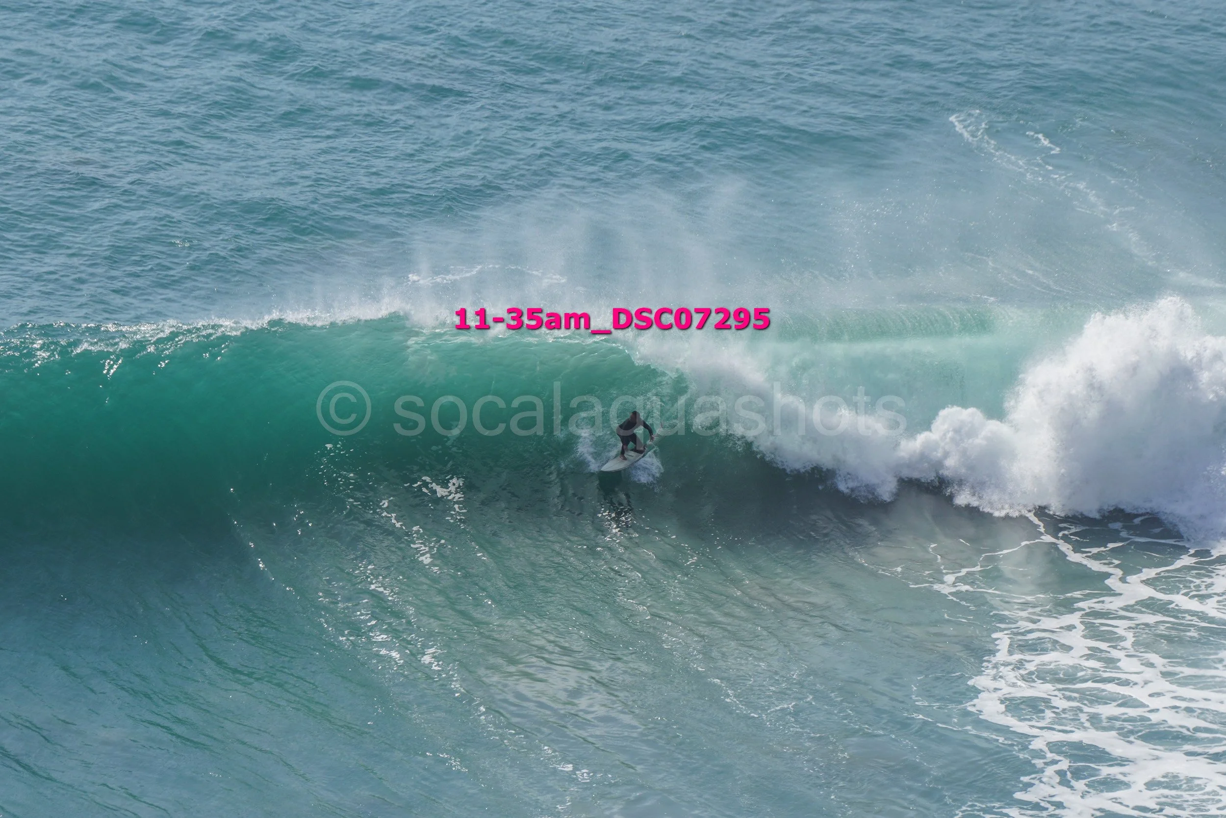 A person surfing on a wave in the ocean.