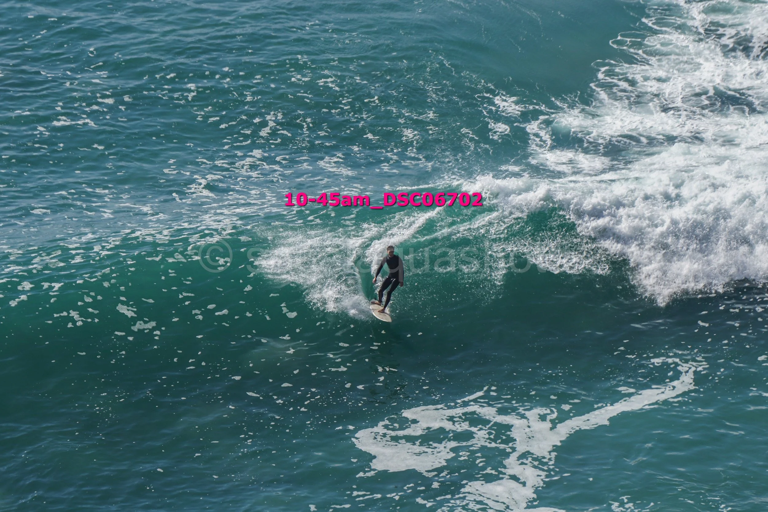 A person surfing on a wave in the ocean.