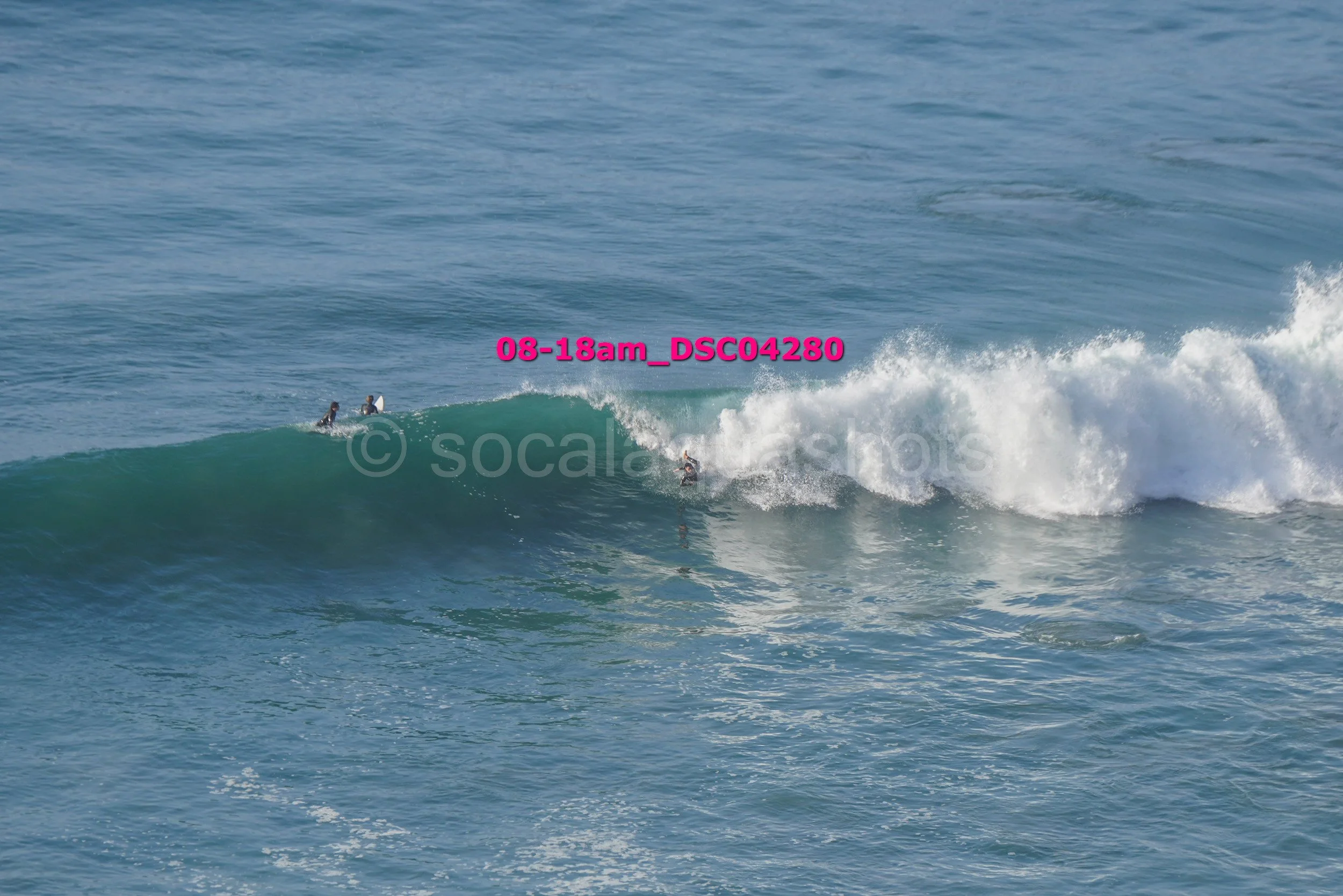 People surfing on ocean waves during daytime.