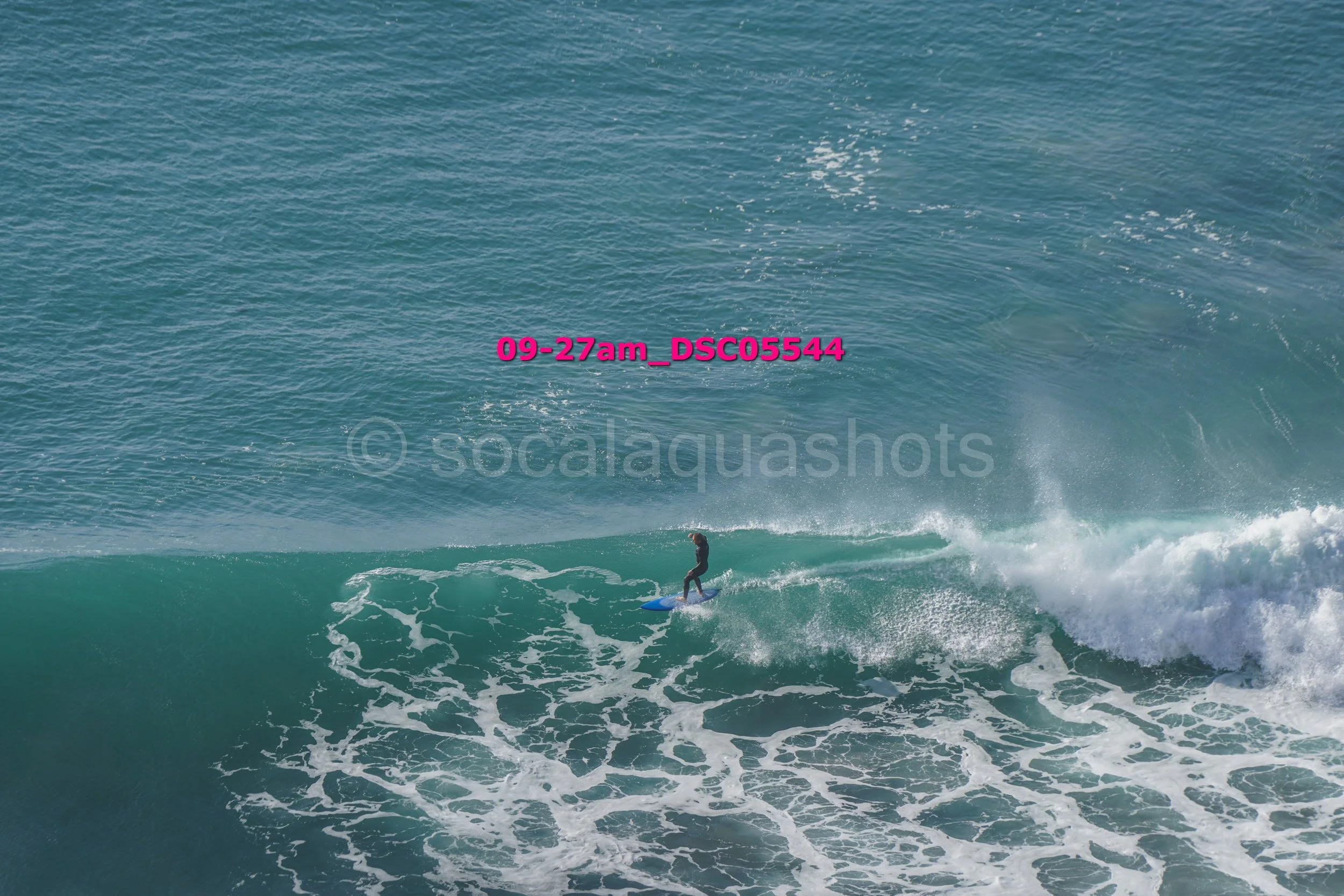 A person surfing on a wave in the ocean.