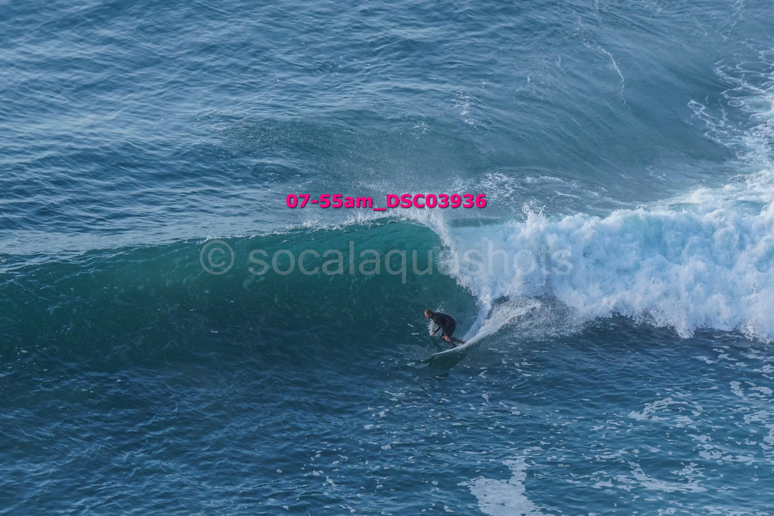 A surfer riding a wave in the ocean during daytime.