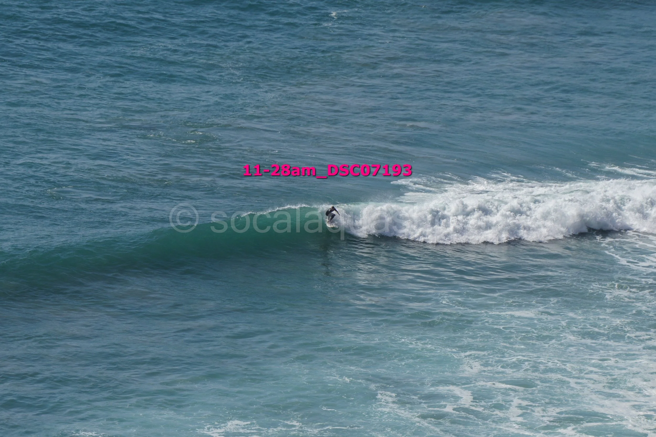 A person surfing on a wave in the ocean.
