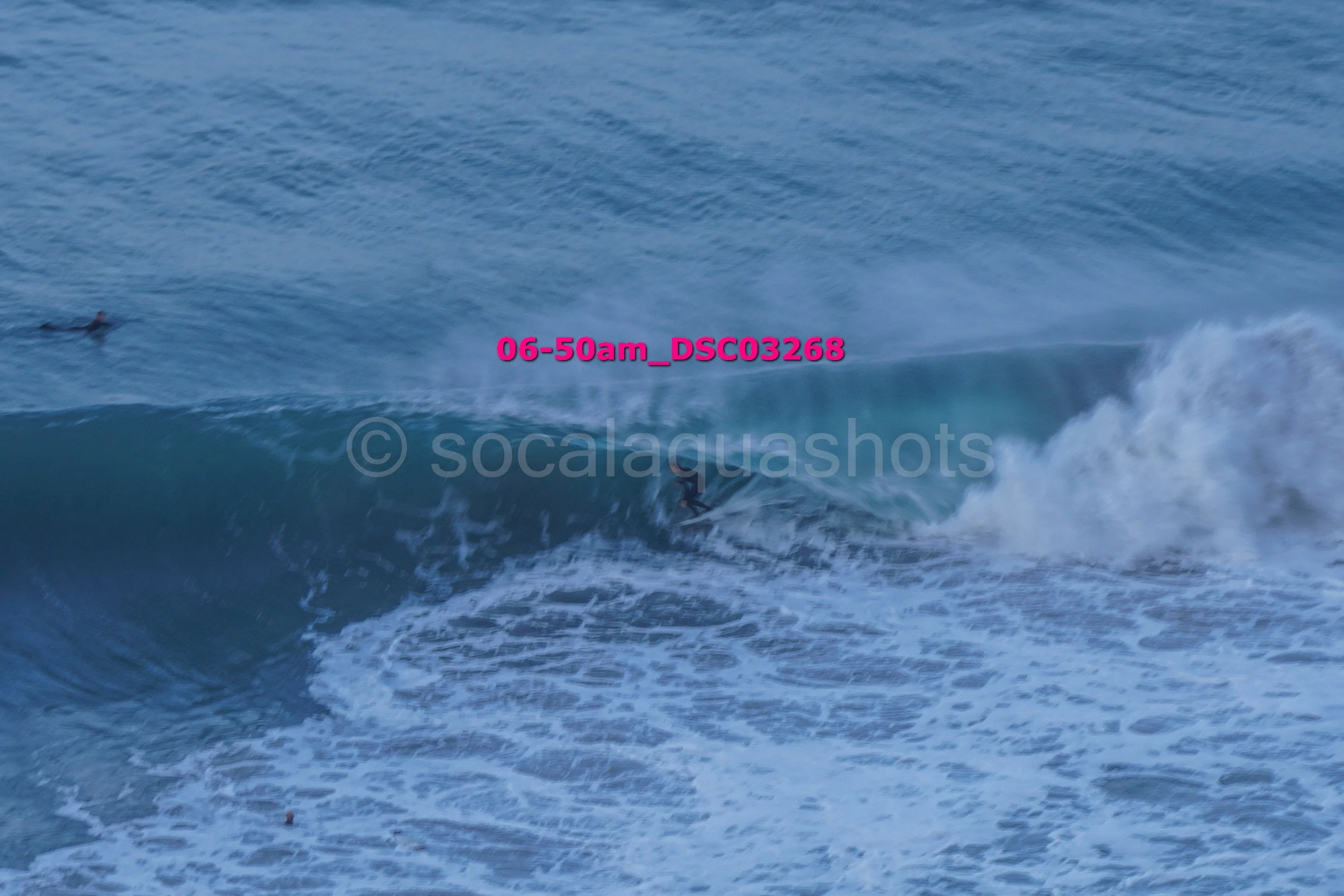 A person surfing on a wave in the ocean.