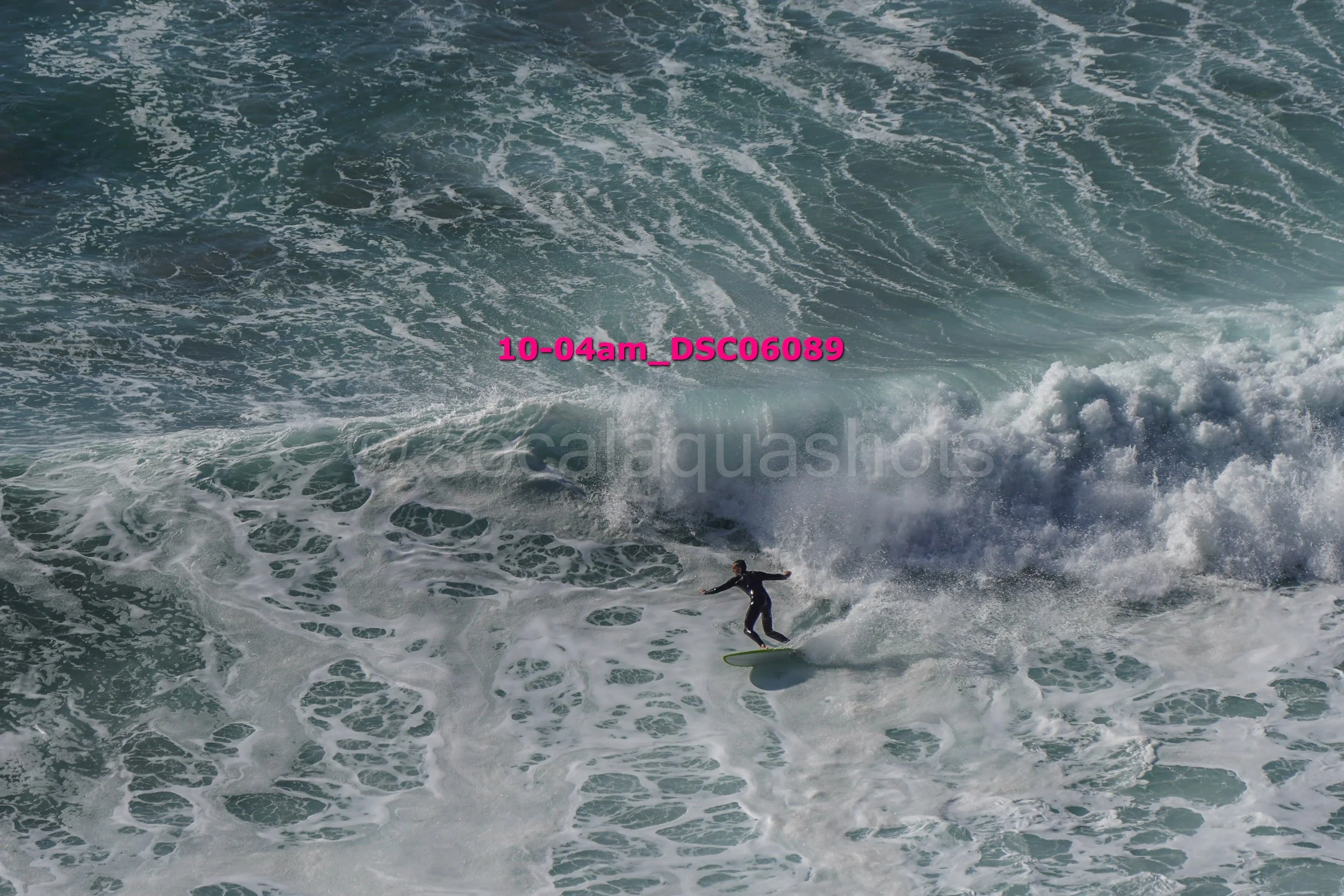 A person surfing on a wave in the ocean.