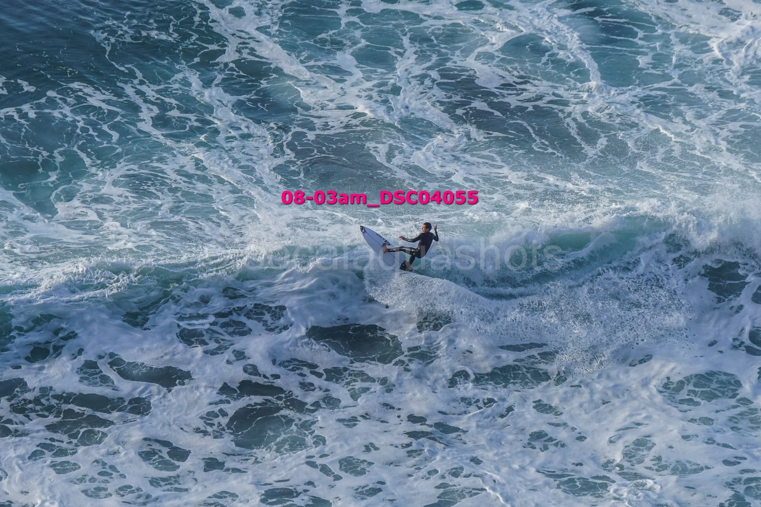 A person surfing on a wave in the ocean.