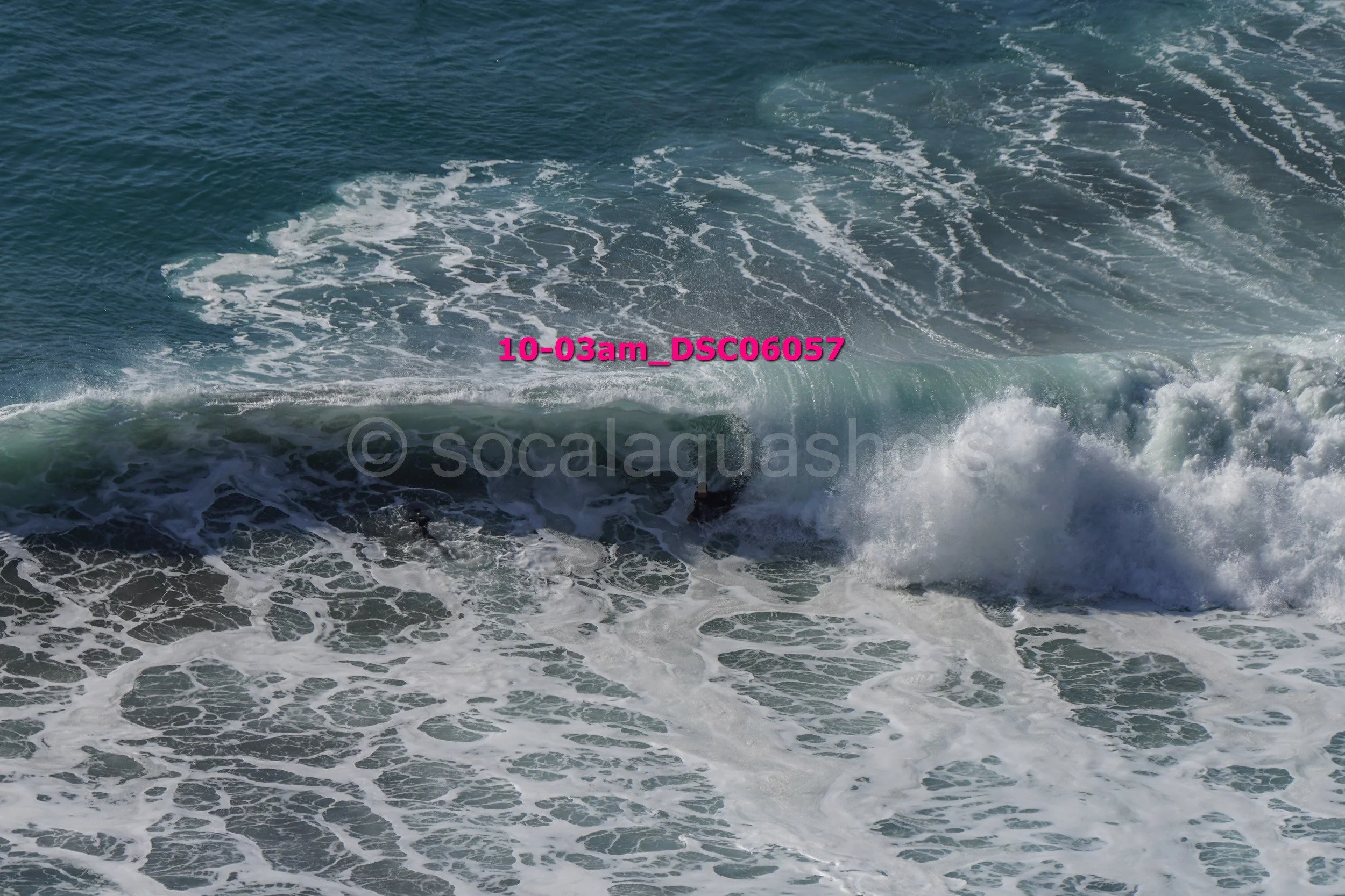 Waves crashing in the ocean with visible foam and turbulence.