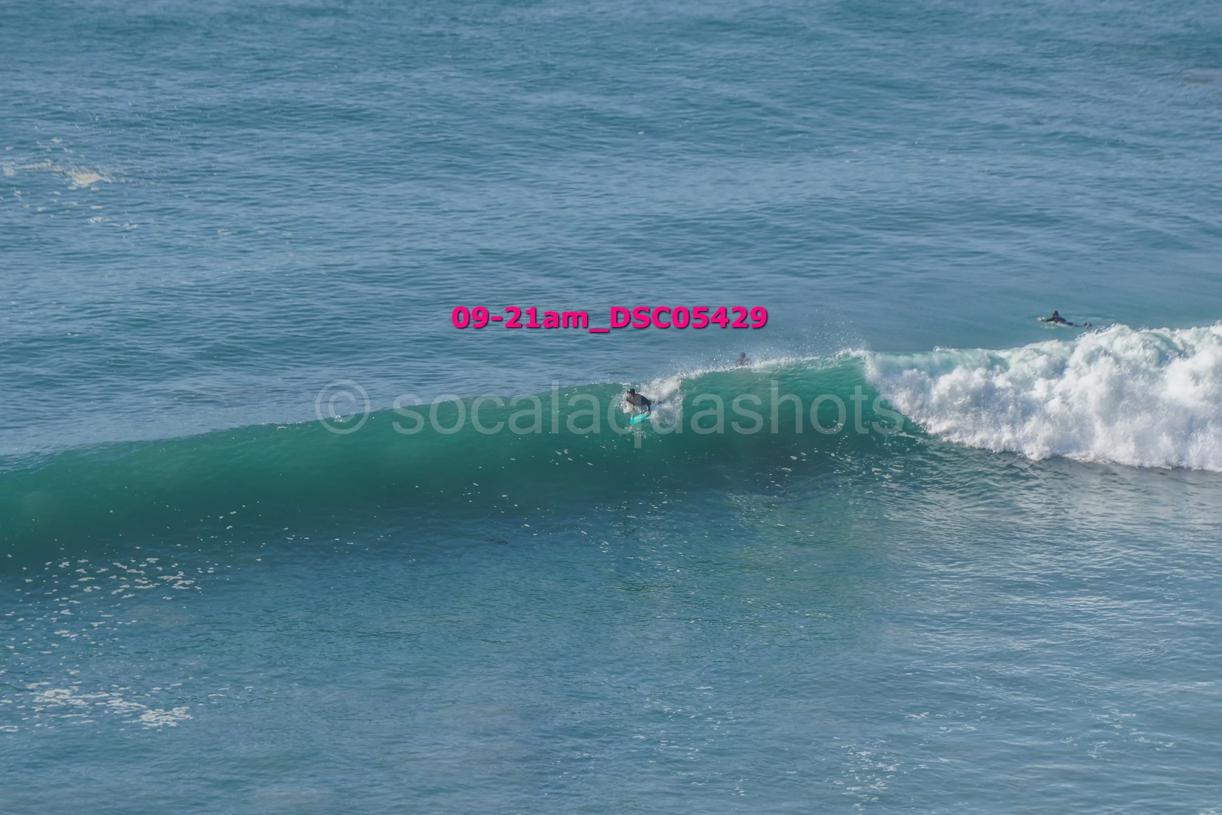 Surfer riding a wave in the ocean.