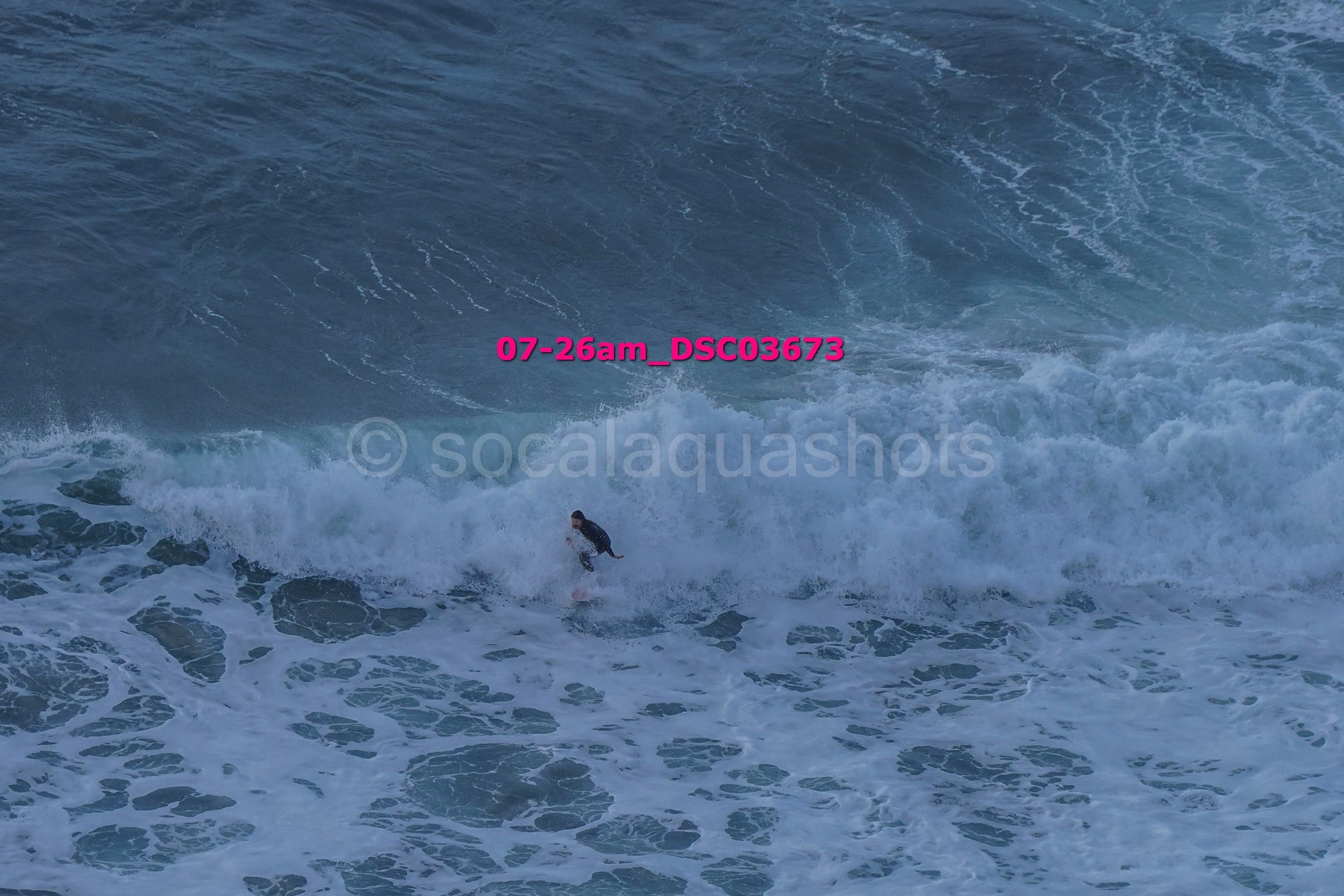 A person surfing on a wave in the ocean.