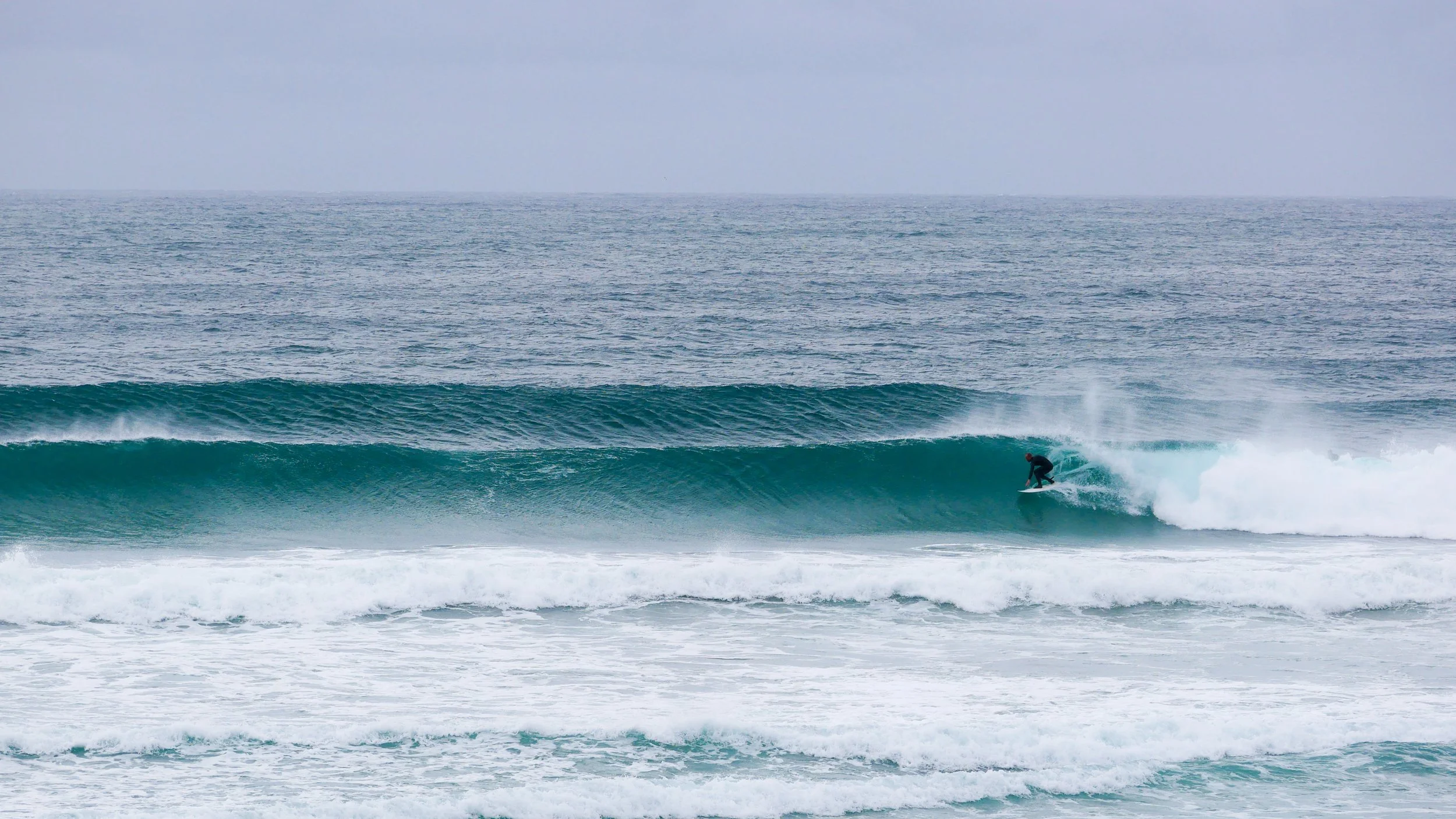 Surfer riding a wave in the ocean