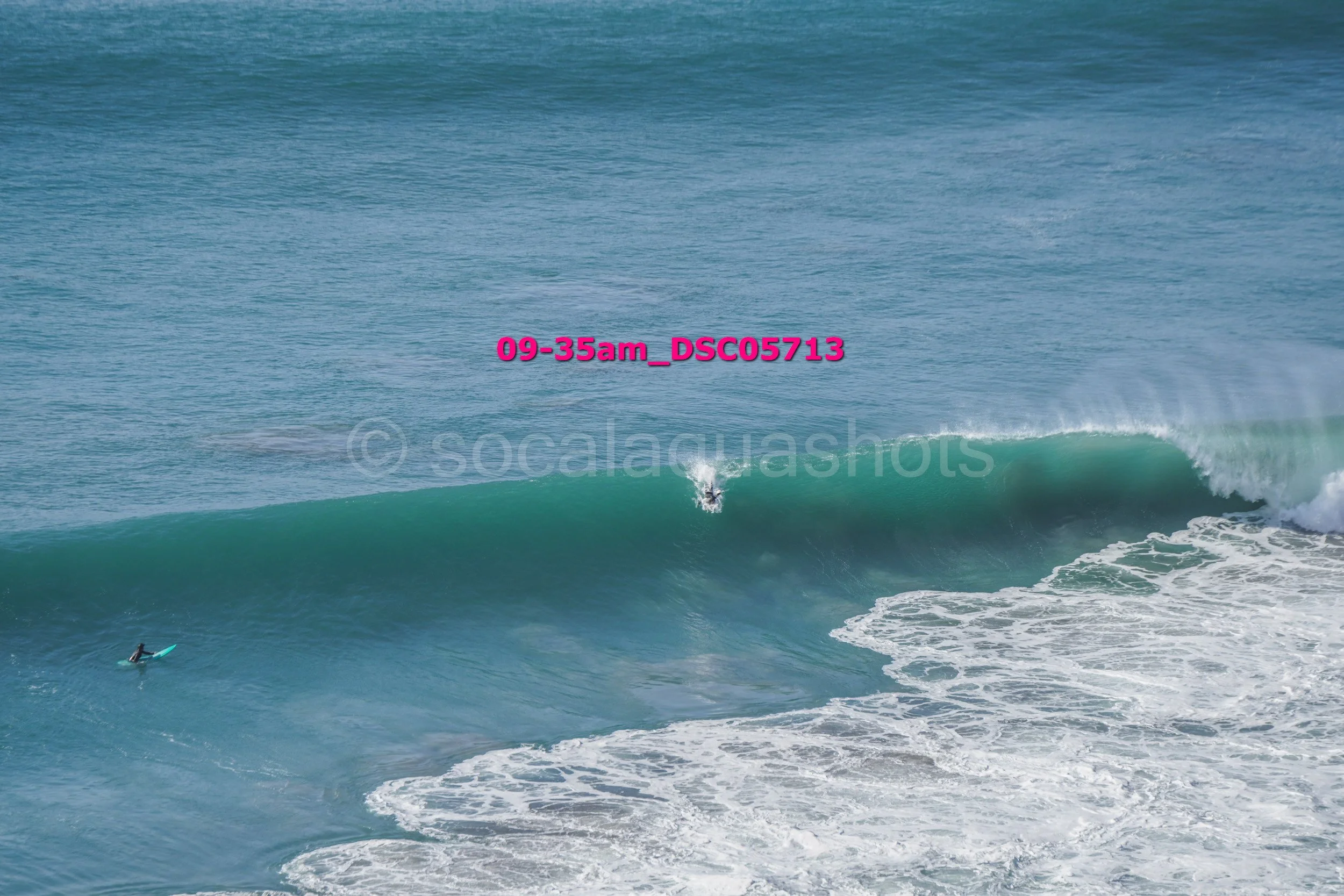 A person surfing on a large ocean wave.