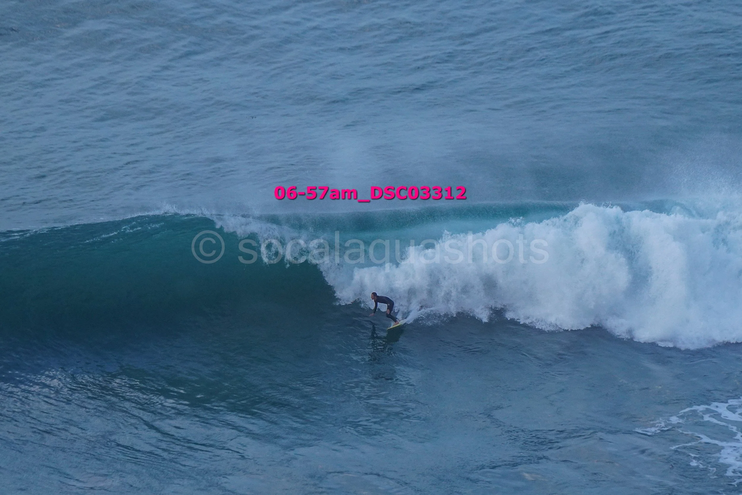 A surfer riding a wave in the ocean.