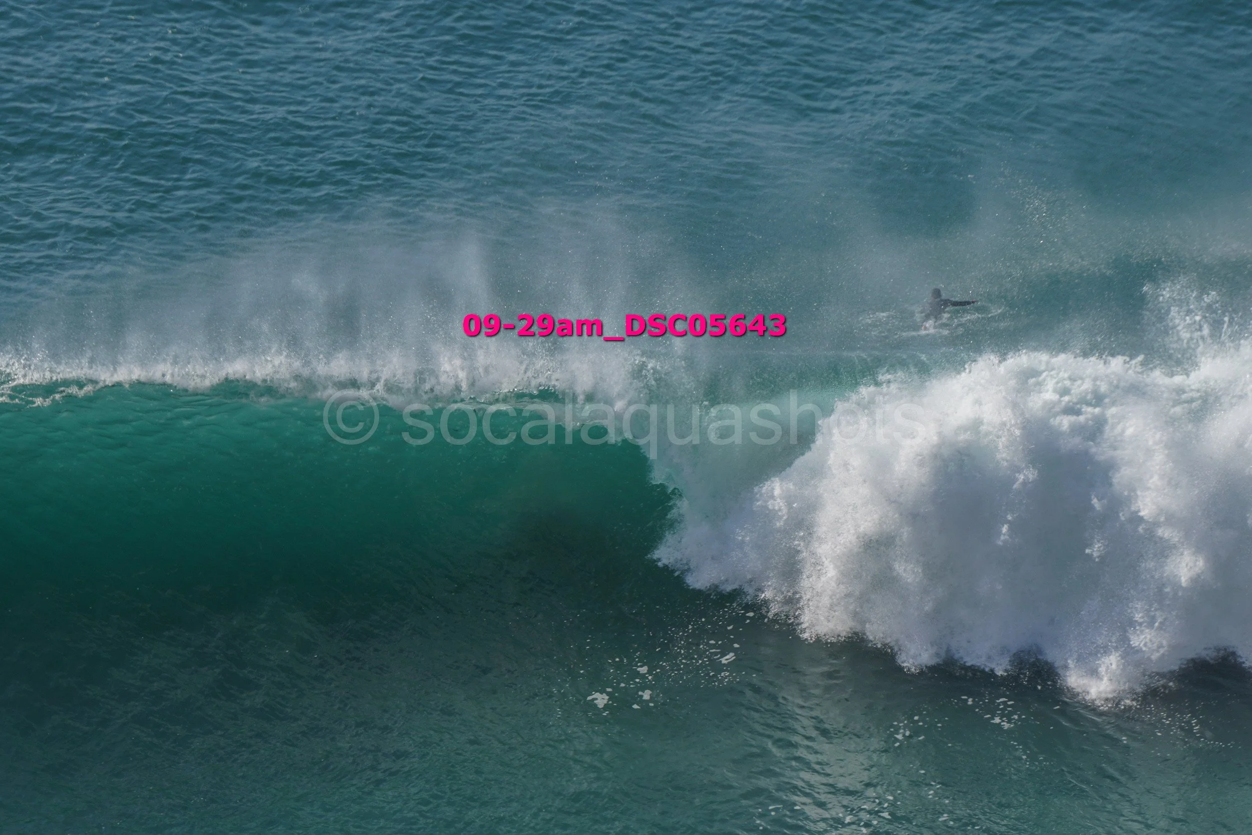A surfer riding a large wave in the ocean.