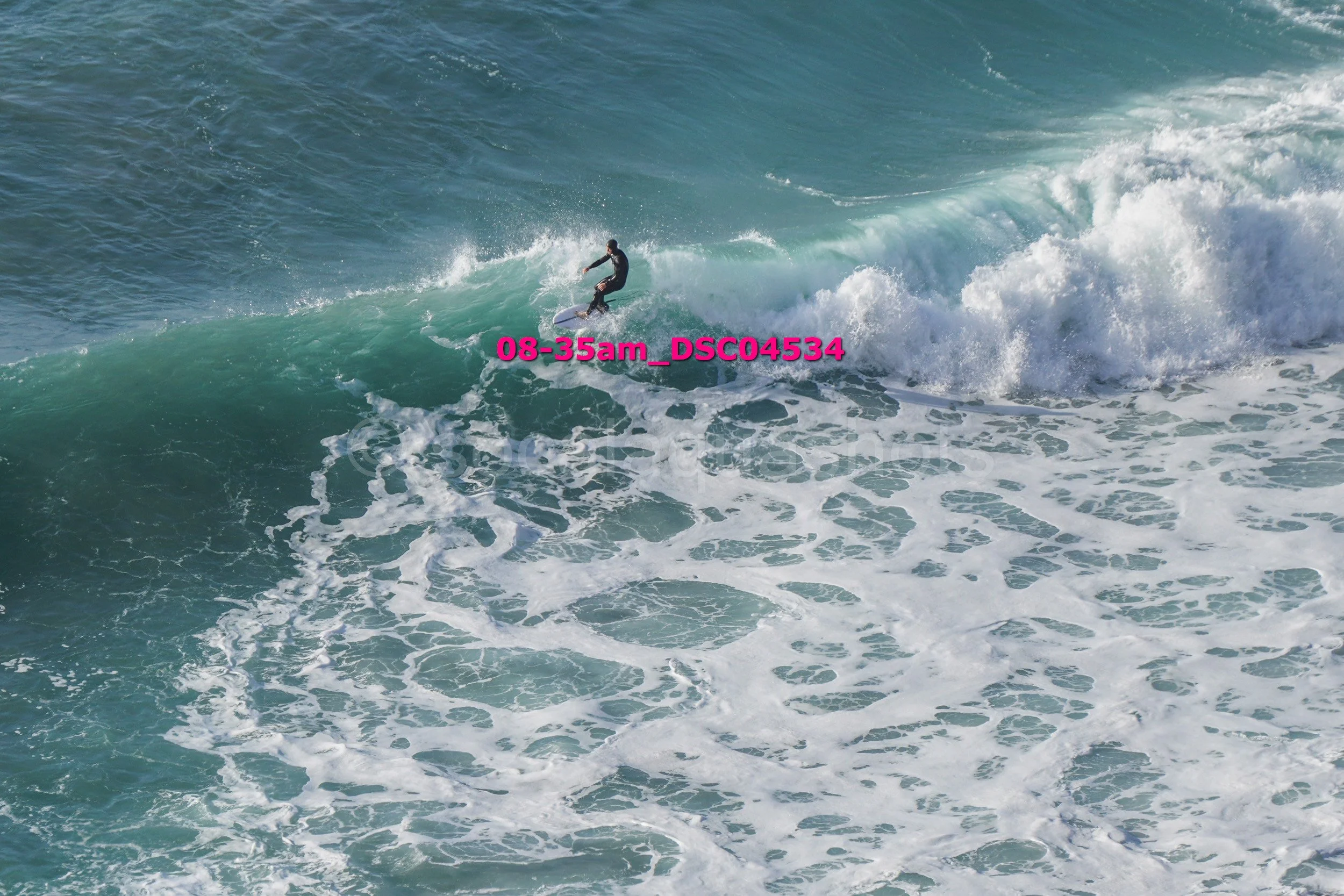 A person surfing on a wave in the ocean.