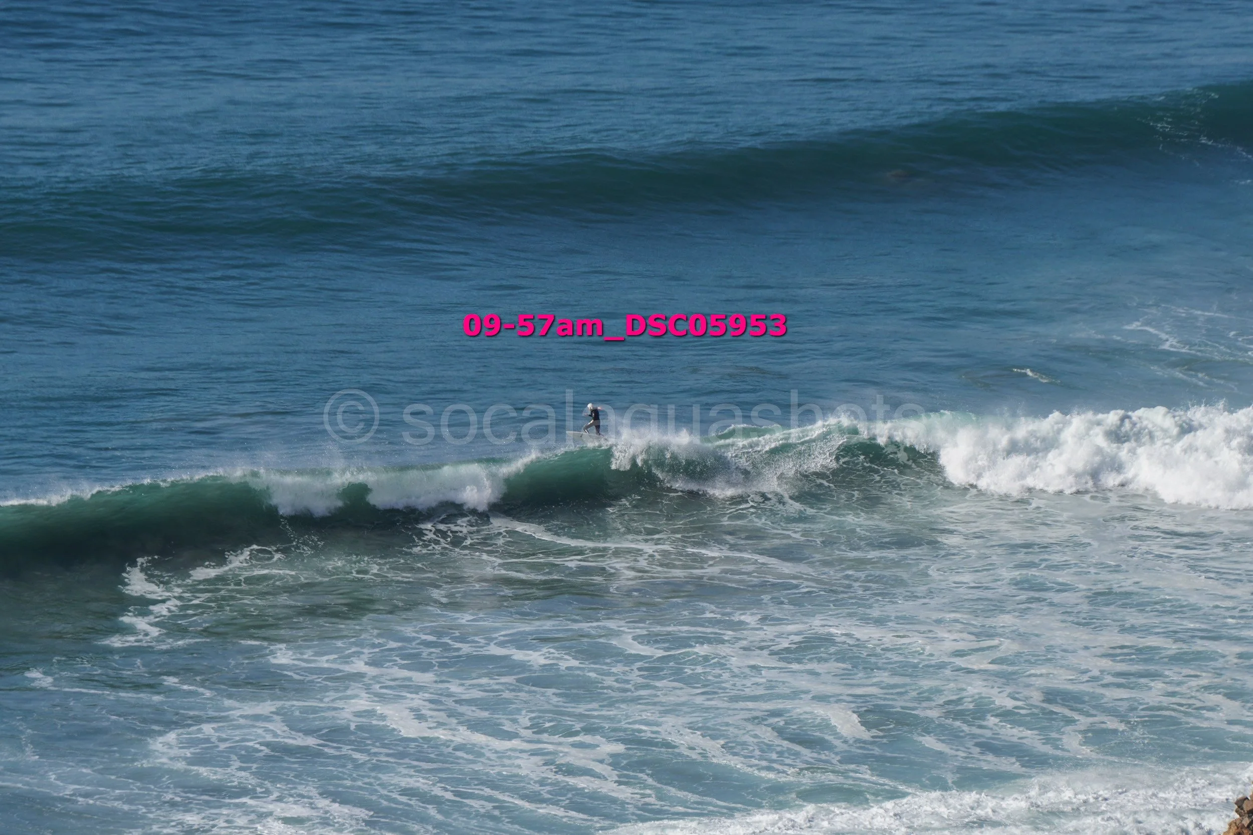 A person surfing on a wave in the ocean.